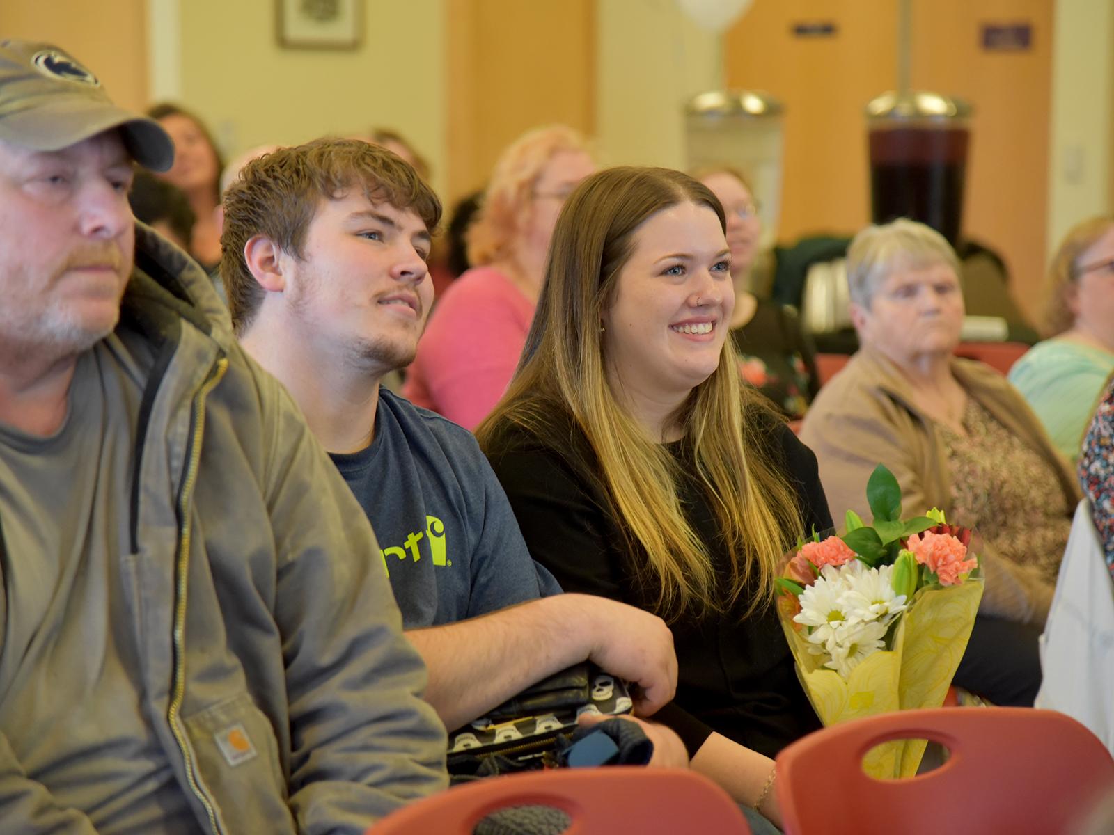 Anisa Miller, an Altoona native and psychology major, listens to remarks during the induction ceremony.