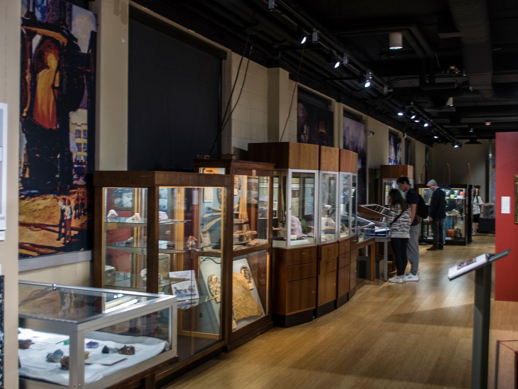 The interior of the Earth and Mineral Sciences Museum and Art Gallery, with exhibits of crystals and minerals, artifacts, and art.