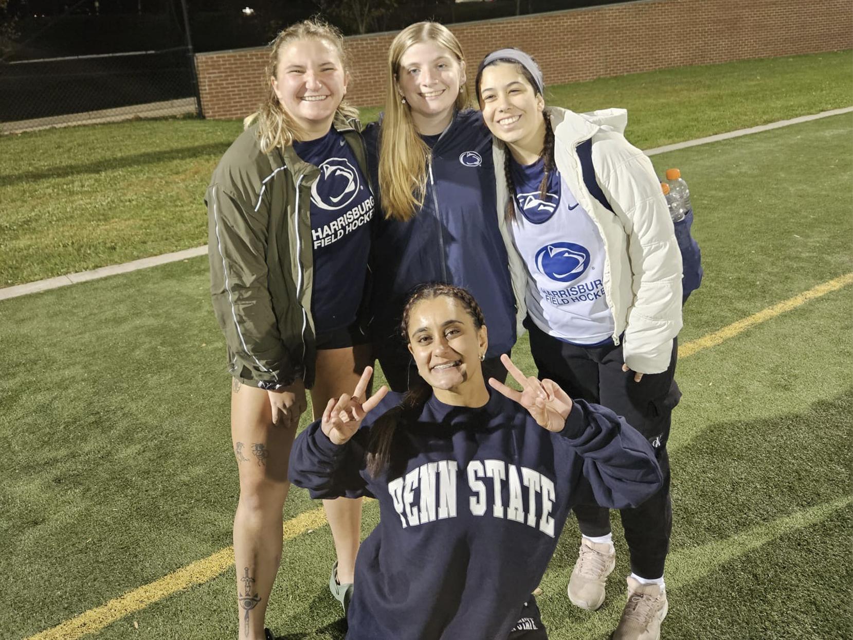 Gurleen Grewal poses with members of the field hockey club team