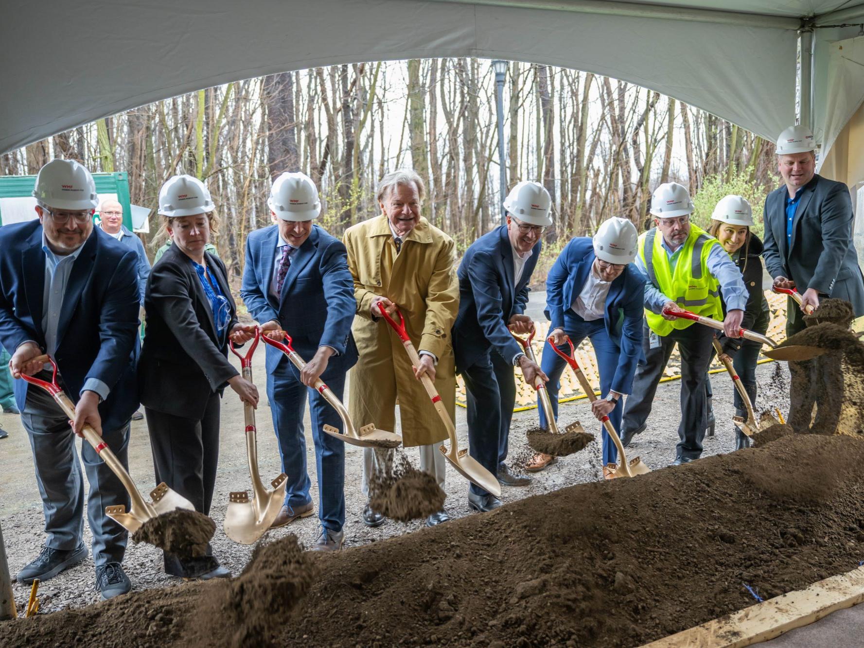 Guests shovel dirt at the groundbreaking ceremony for a new KYOCERA AVX facility at Penn State Behrend