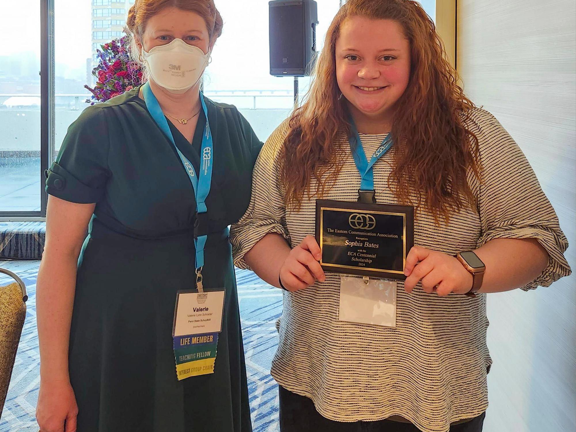 two people with an award 