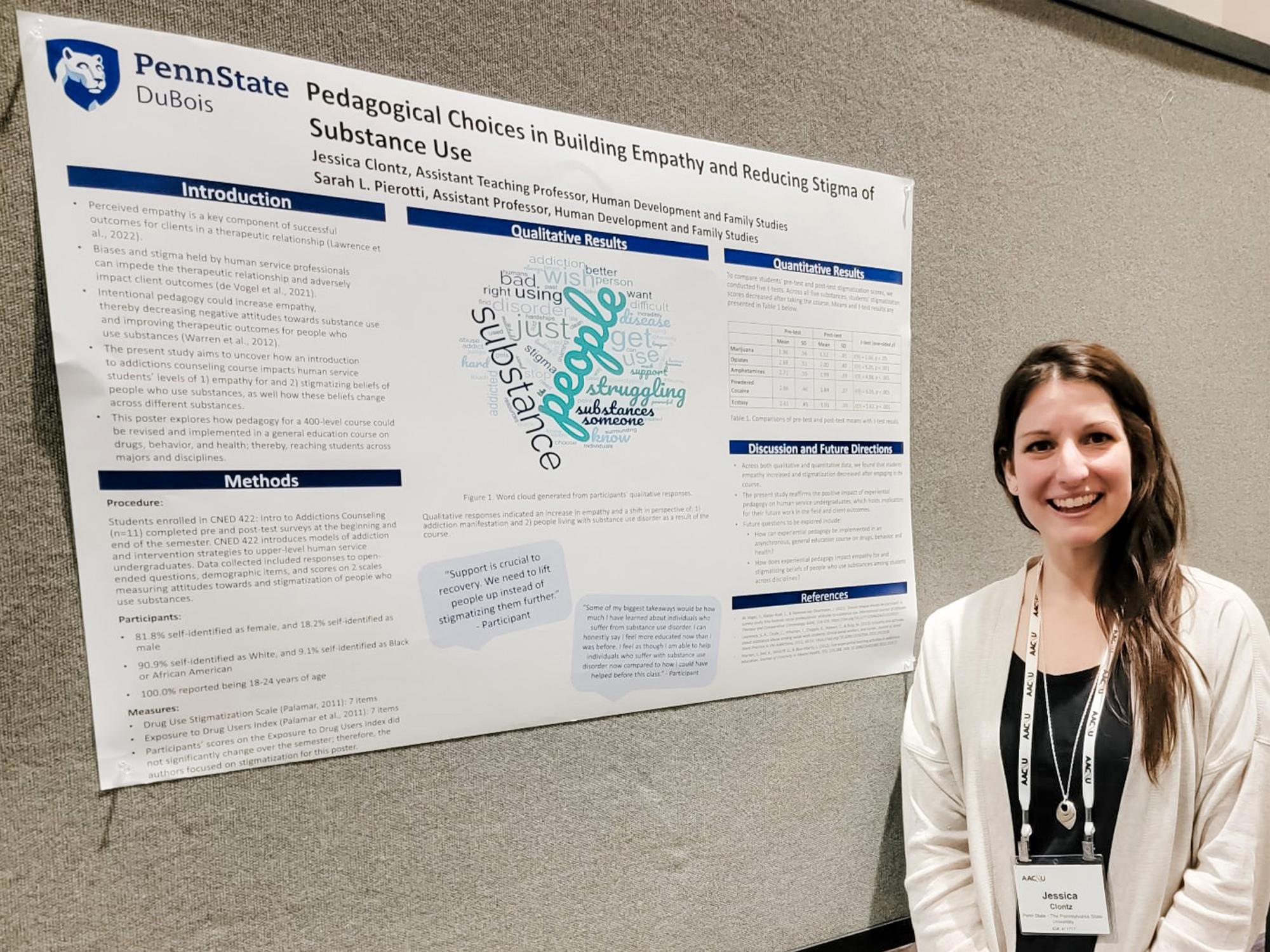 Person stands next to a research poster