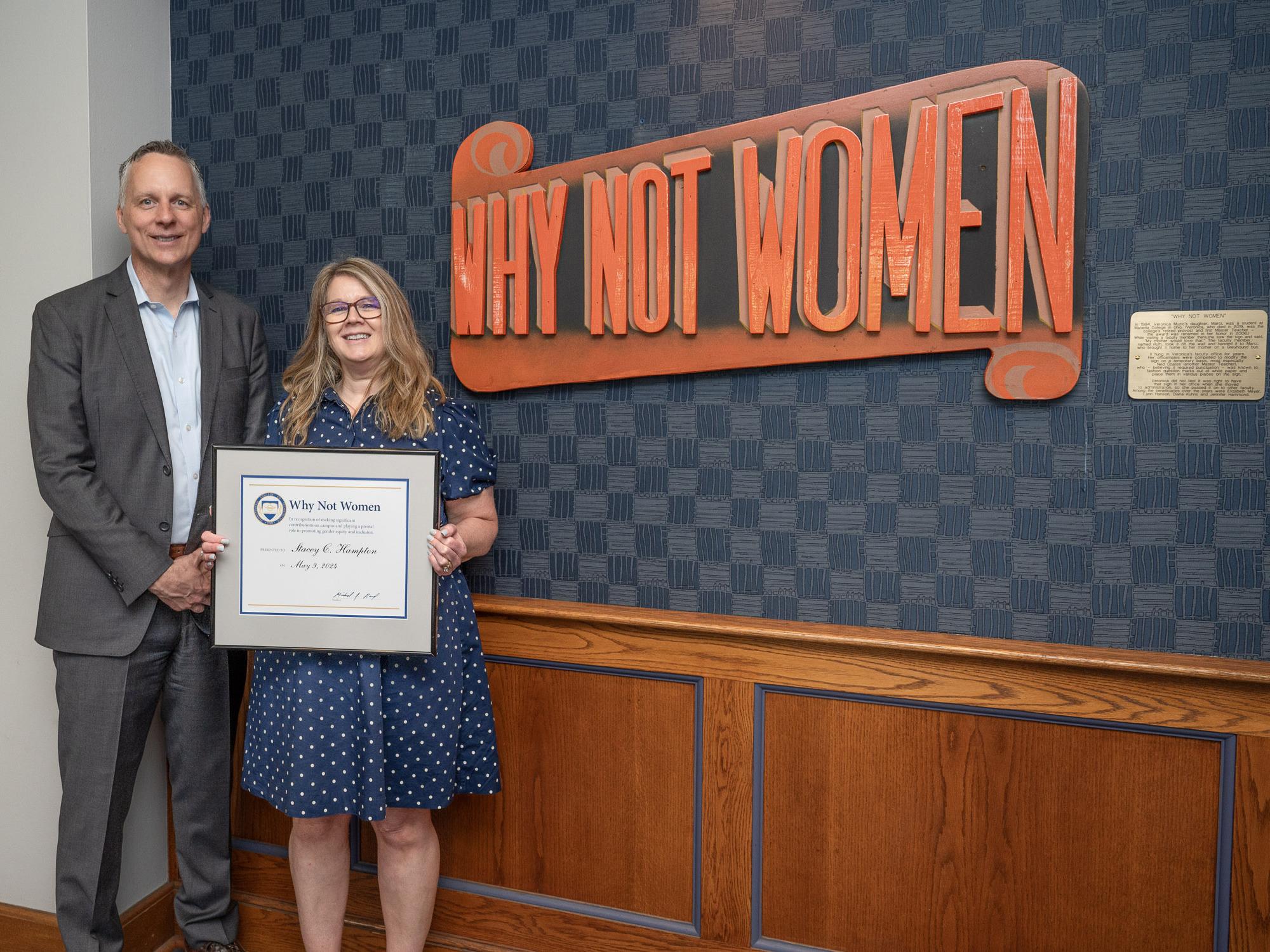 a person accepting an award from another person