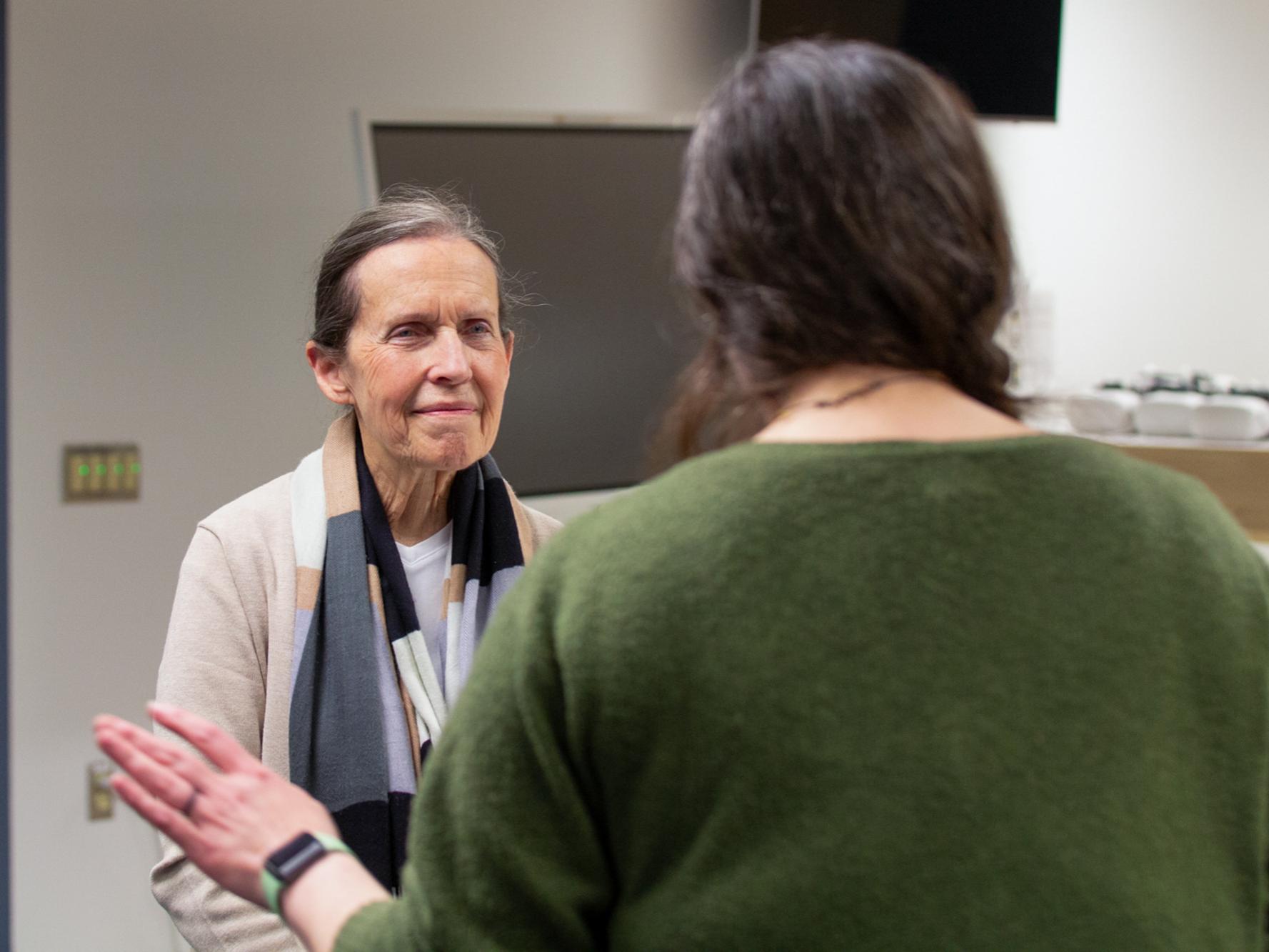 Susan Grove speaking with another individual at the Evidence-Based Teaching Academy