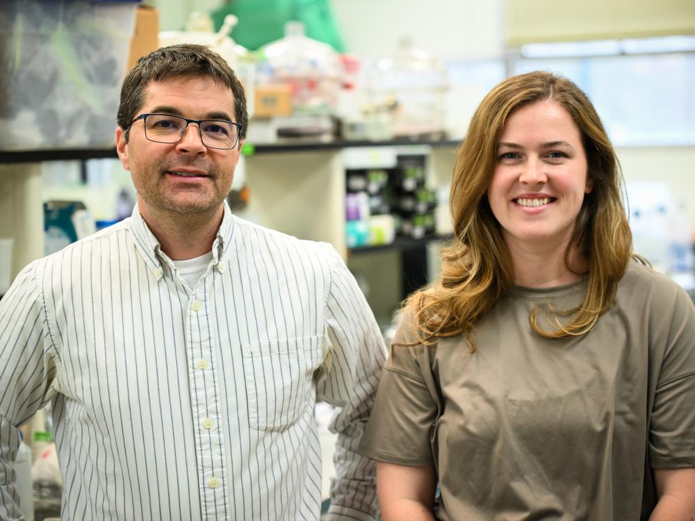 Two individuals pose in a lab