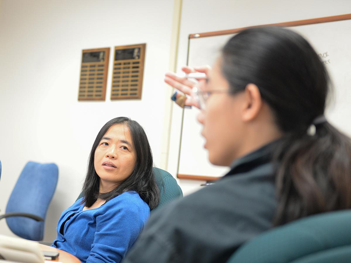 Li Li listens to a student's feedback during a presentation.