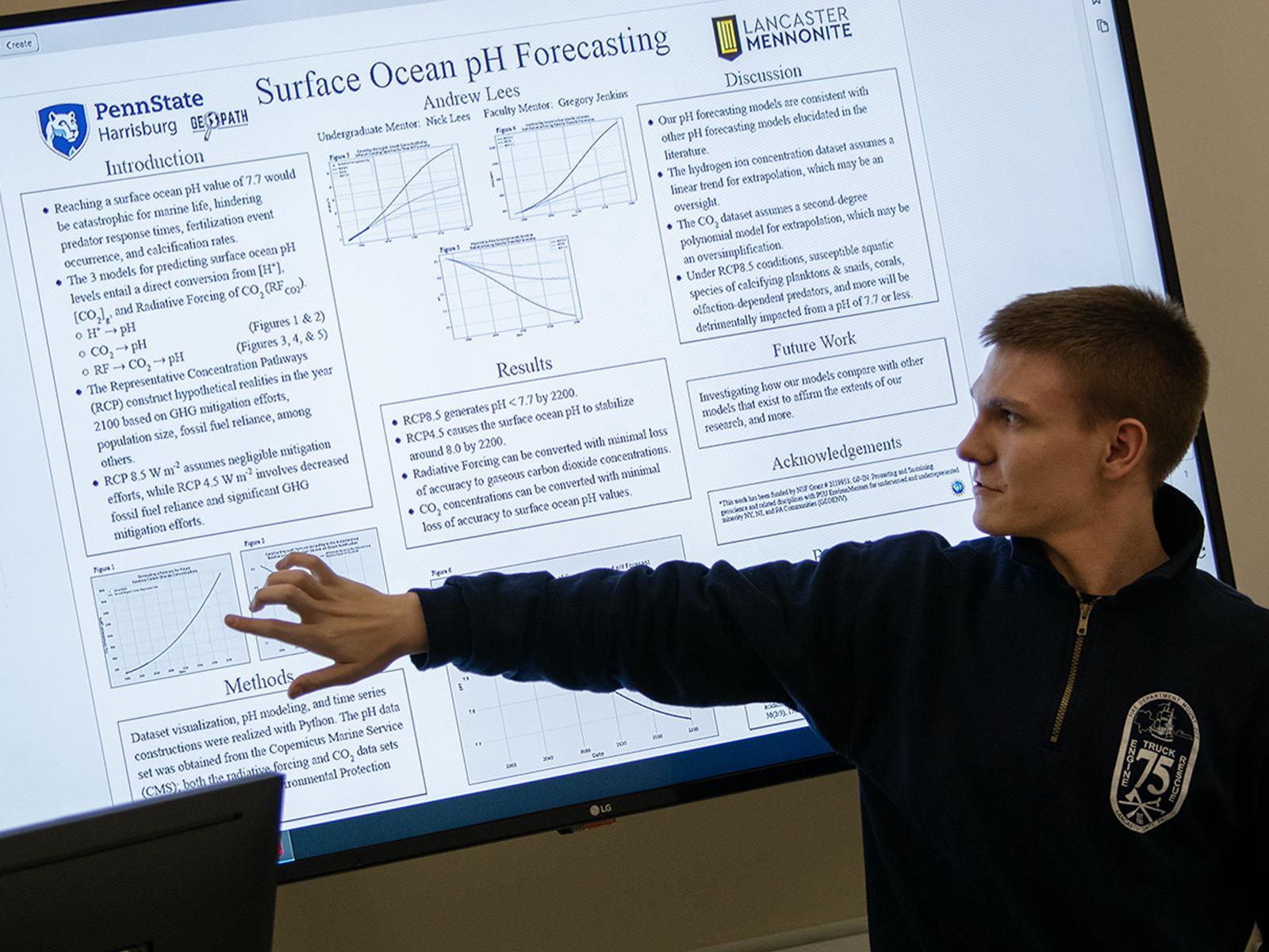 High school student Andrew Lees points to a screen showing his research project