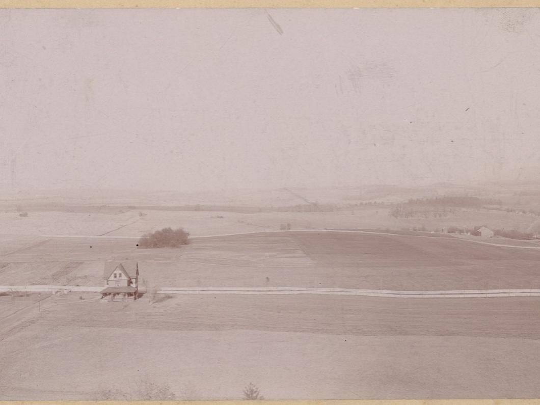 A picture of two single buildings on a college campus in the 1890s