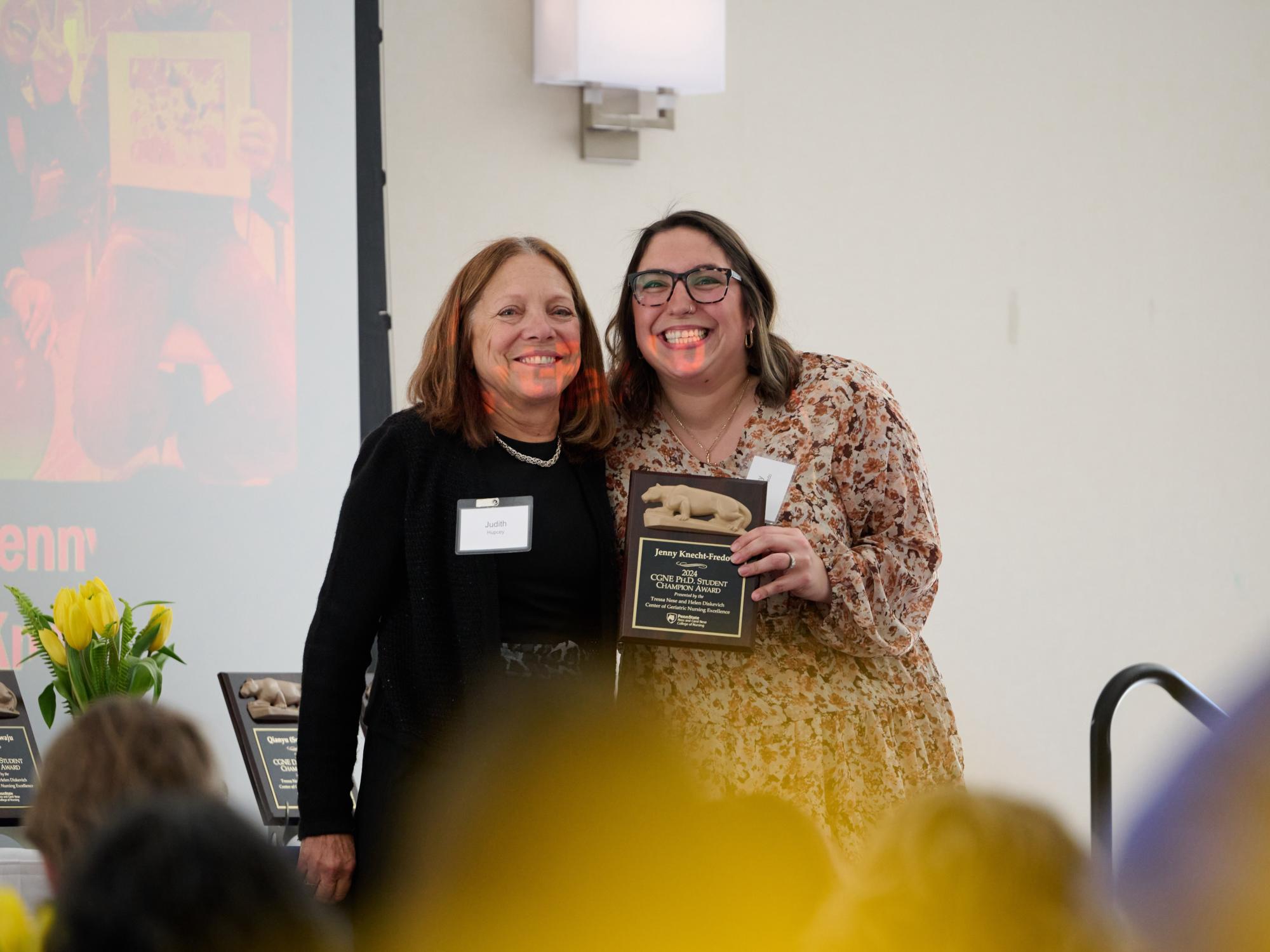 Jenny Knecht Fredo (right) receives her award from Dr. Judy Hupcey.