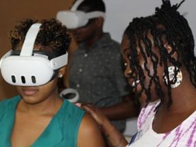 Two people, one in a VR headset