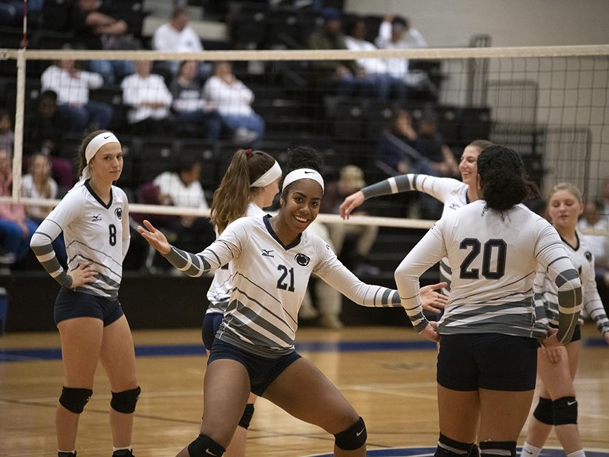 Women's volleyball players on the court.