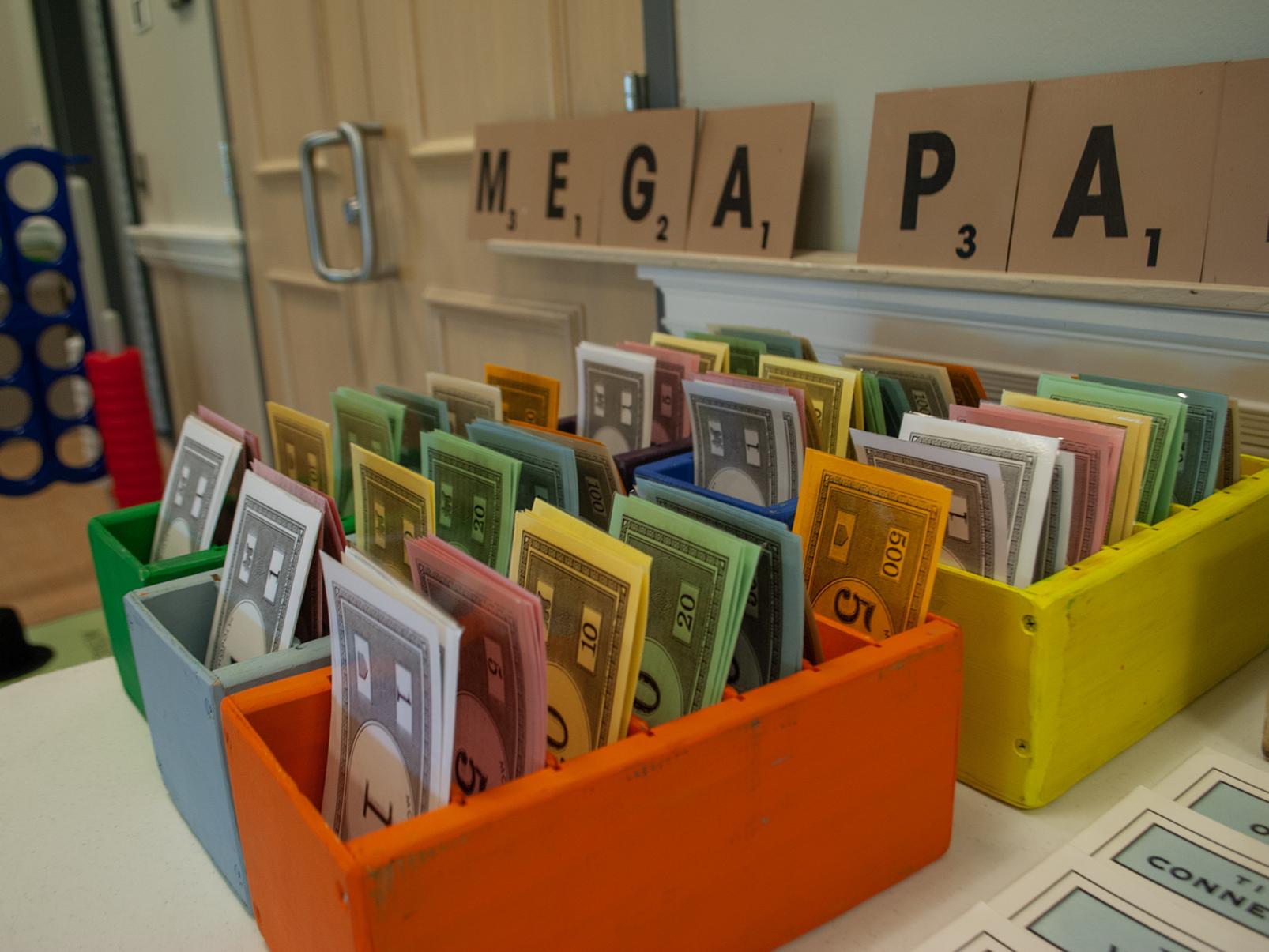 Bins containing play money are displayed for Mega Party Rentals, a business run by a Penn State Harrisburg student