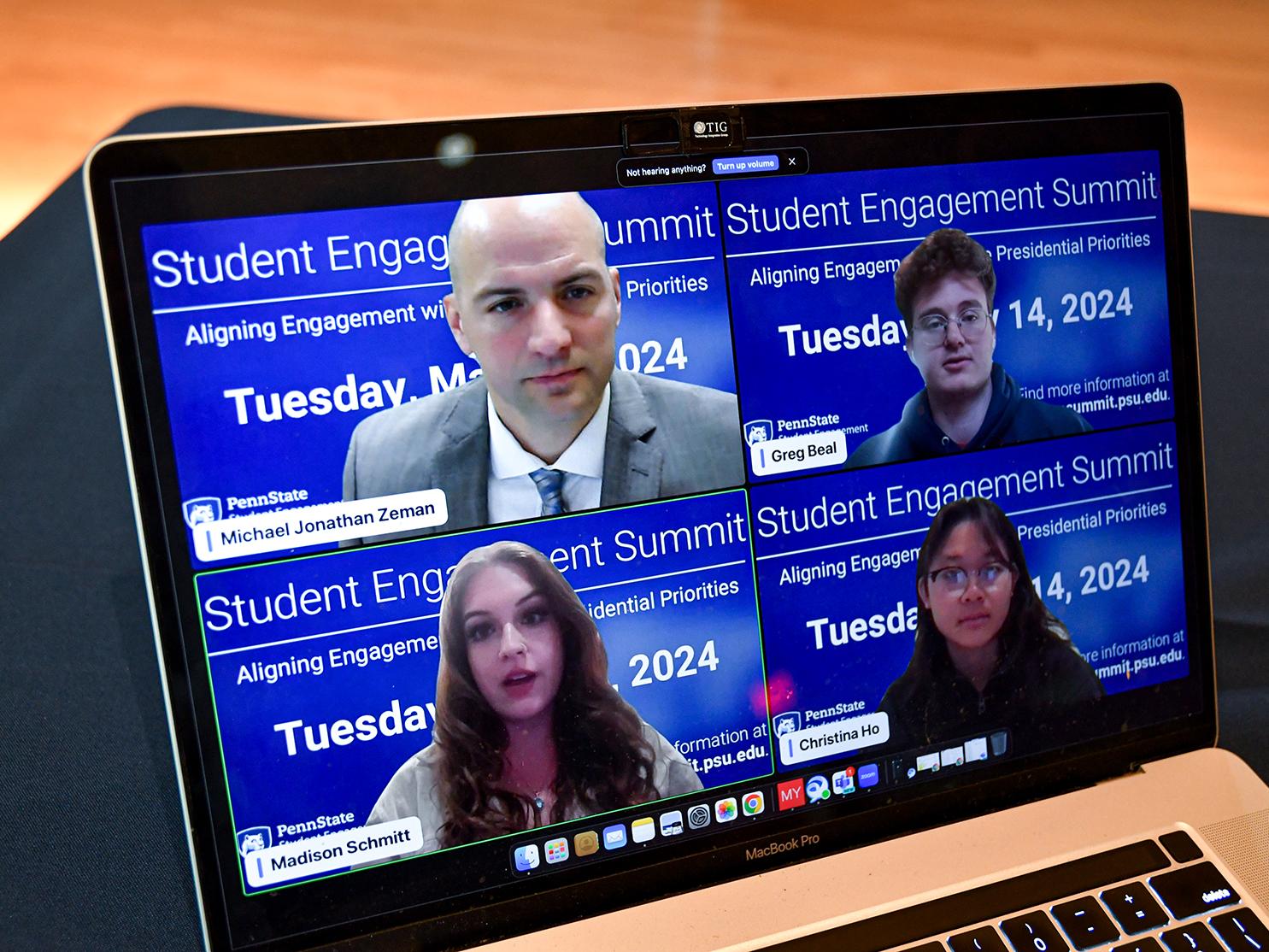 Four people in a Zoom meeting, shown on a laptop