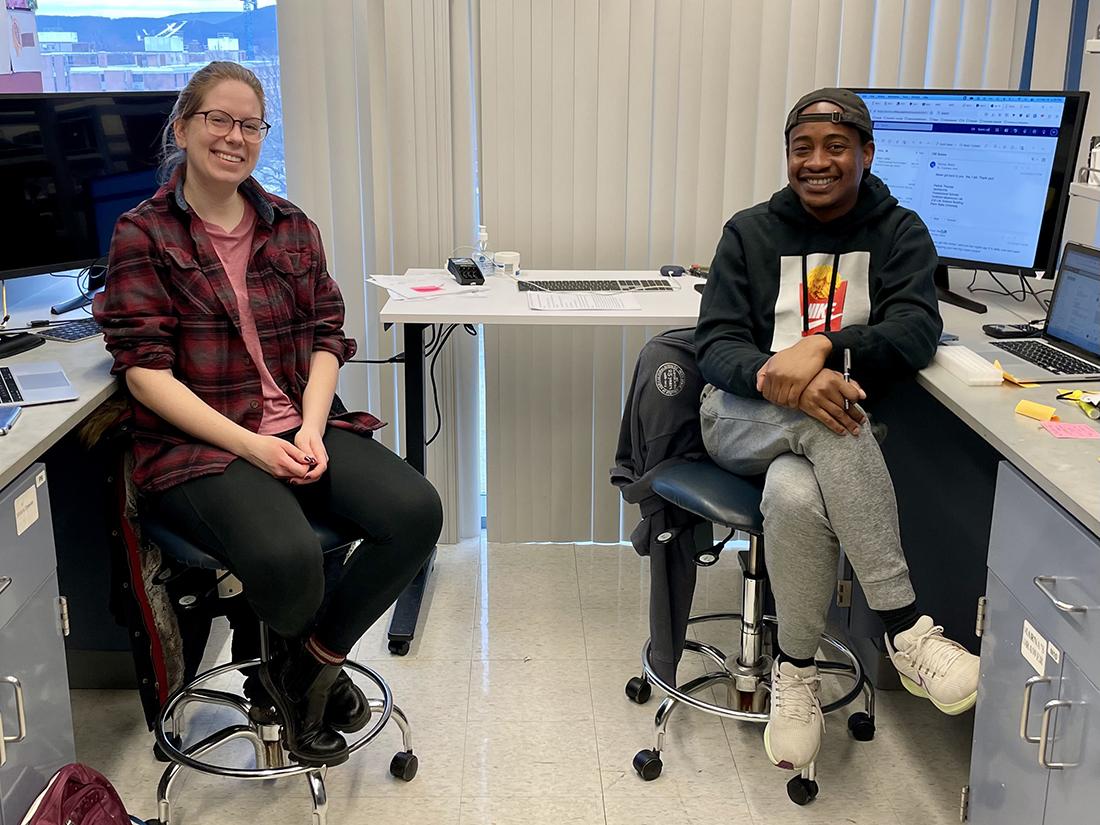 Two people sitting in front of computers