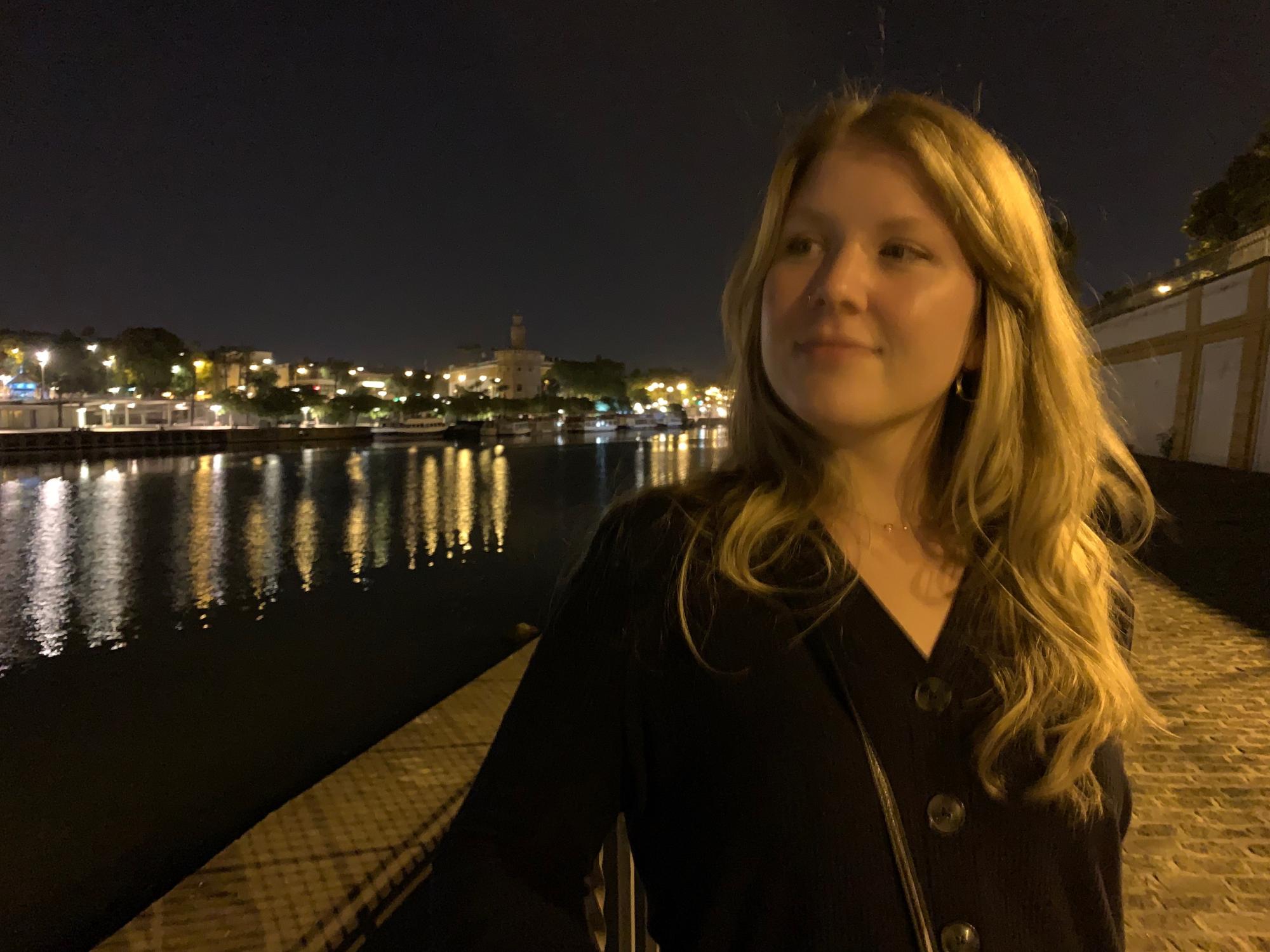 Katherine Godfrey stands against river backdrop 