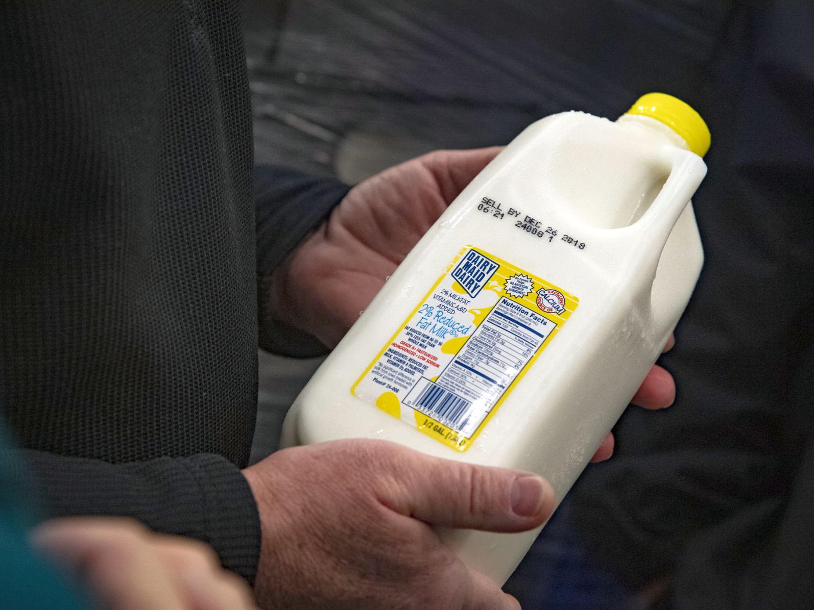 Man holding milk in a half-gallon jug