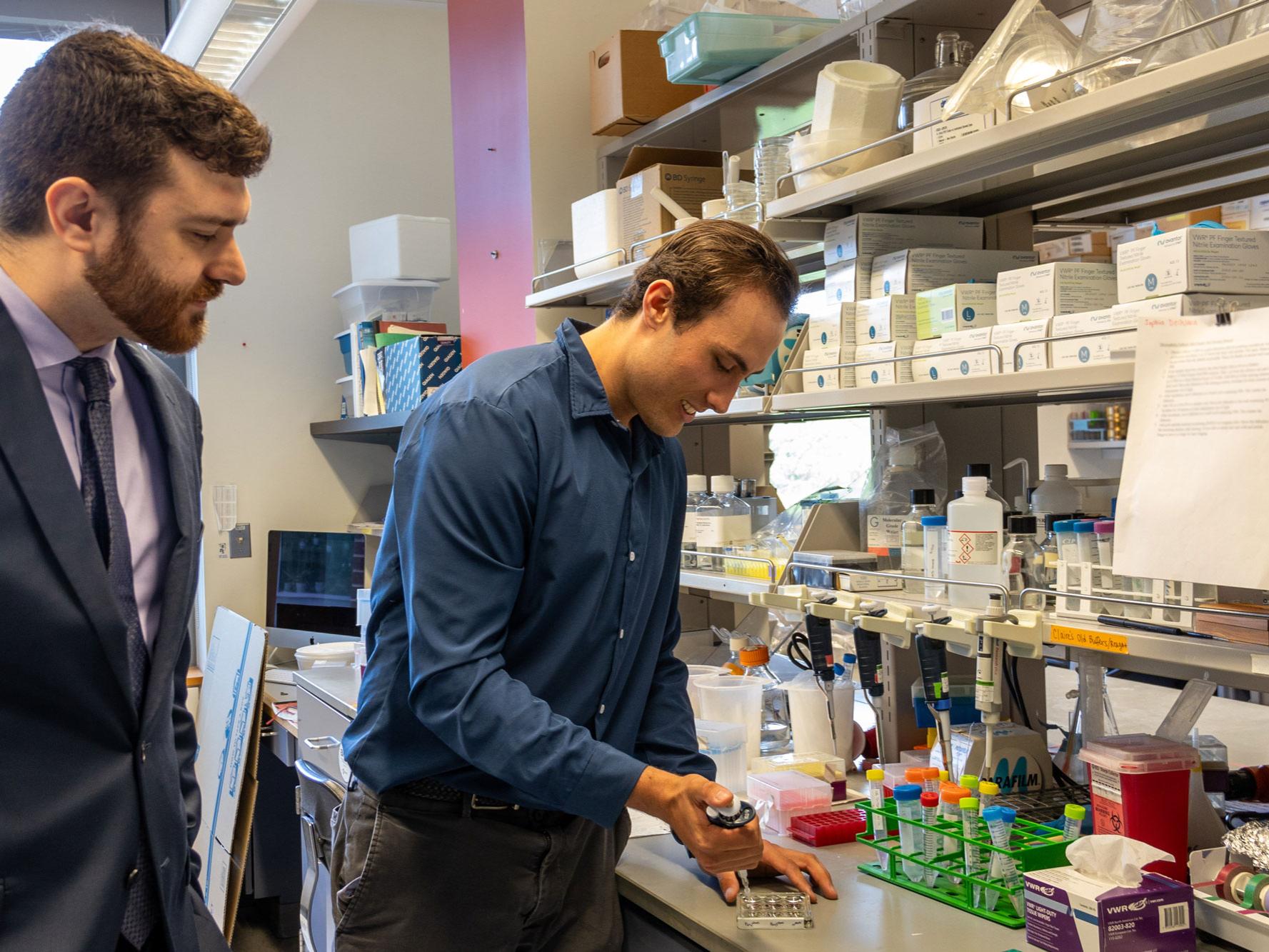 Two men work at a lab bench