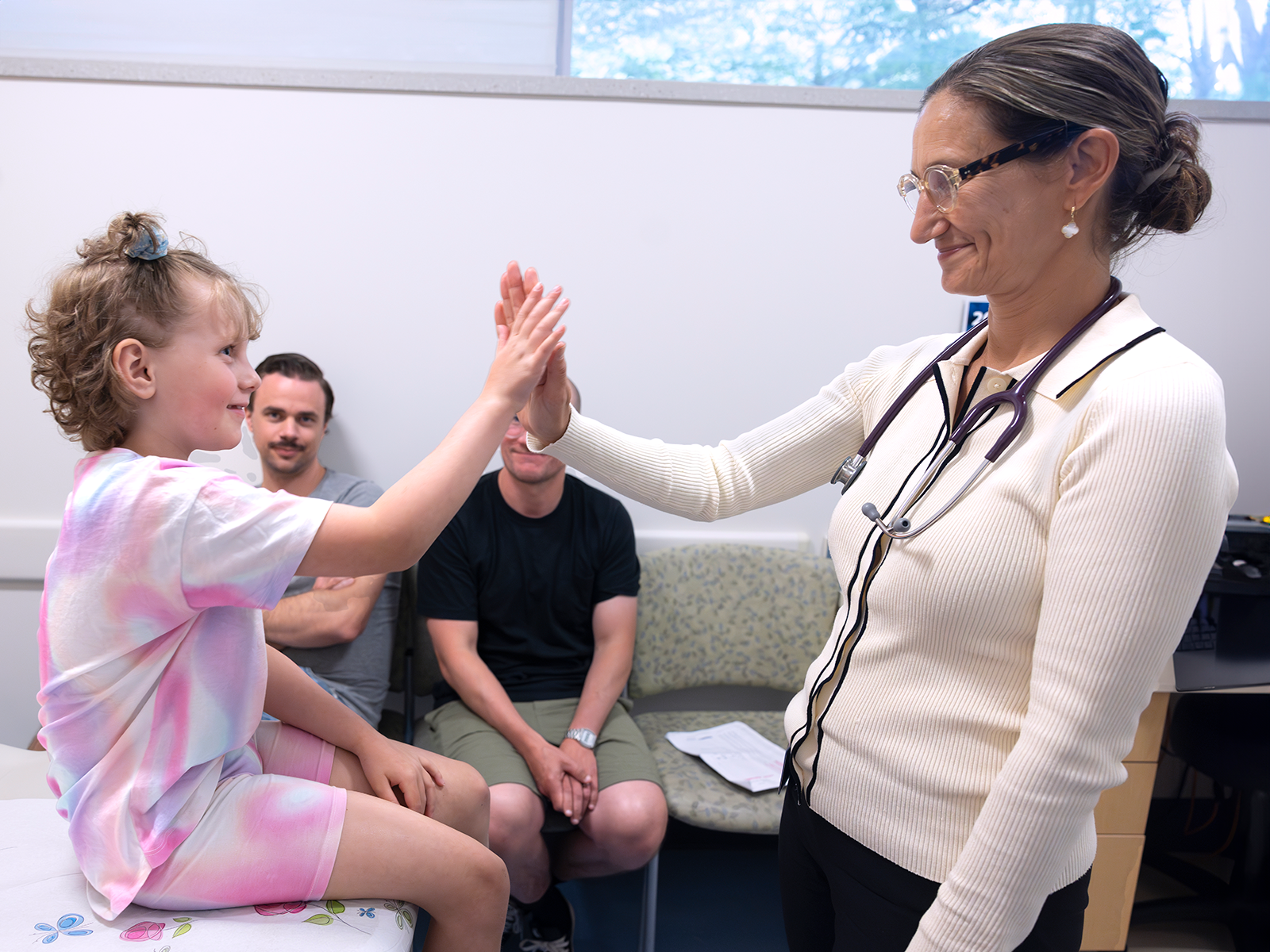 Doctor giving child patient a high-five
