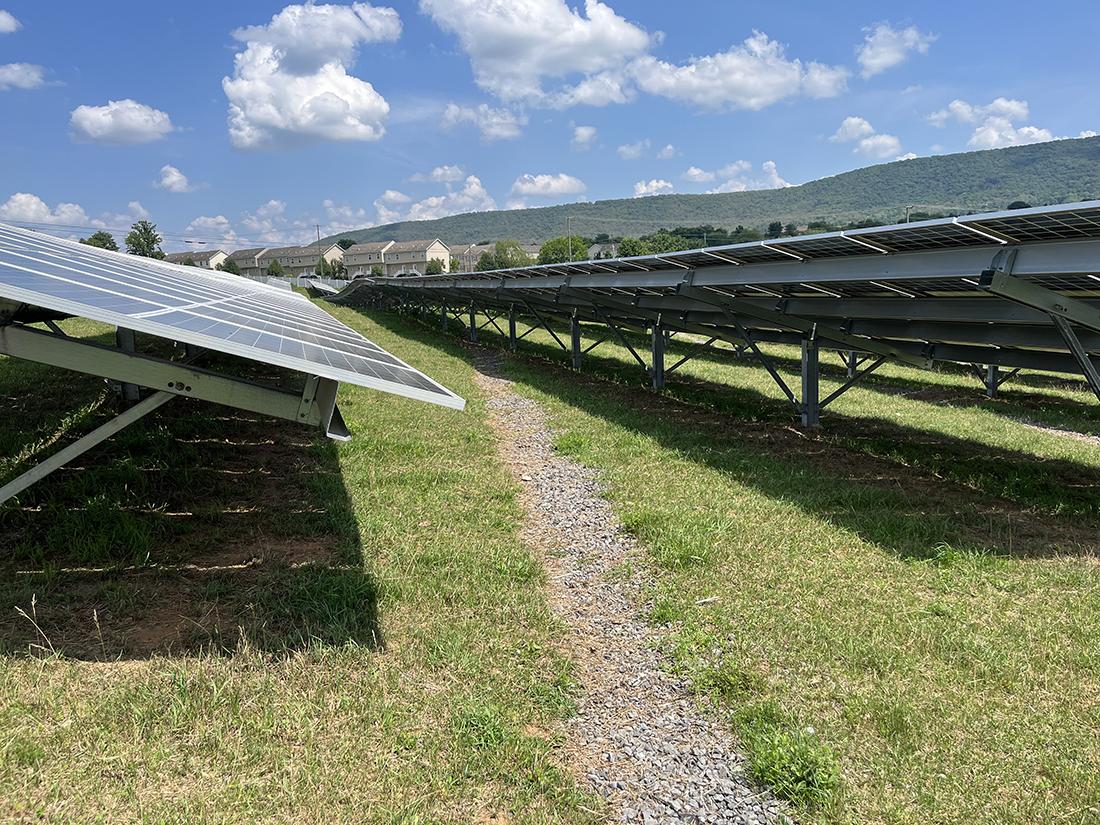 Gravel path running between two solar panels