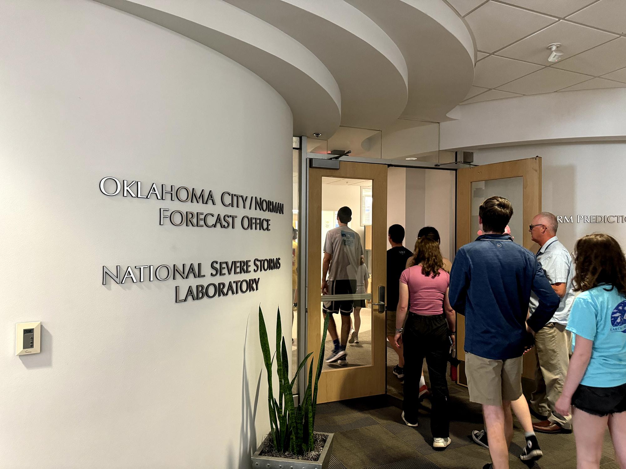 People walking through a double door. 