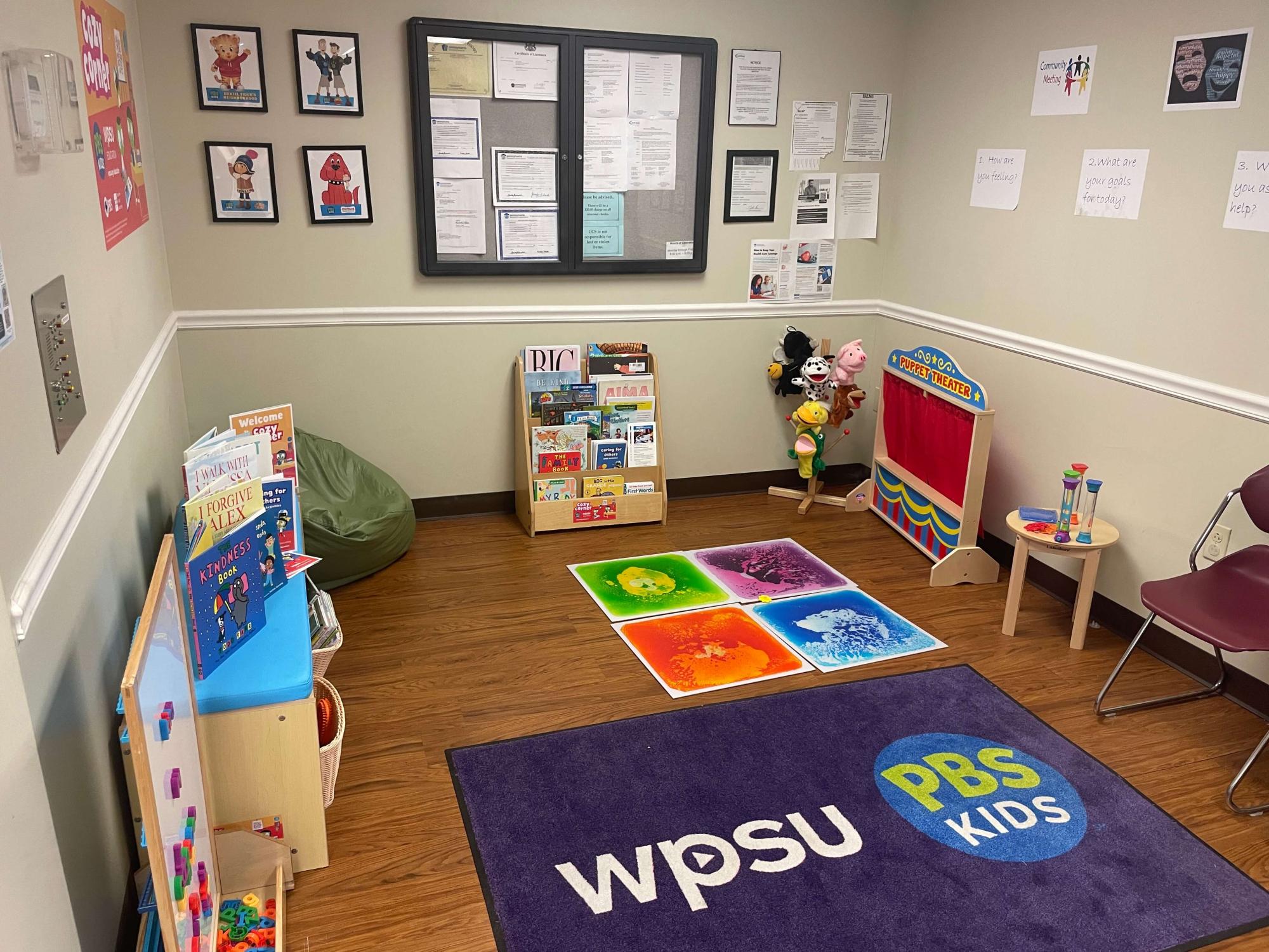 children's play area with books, toys and puppets