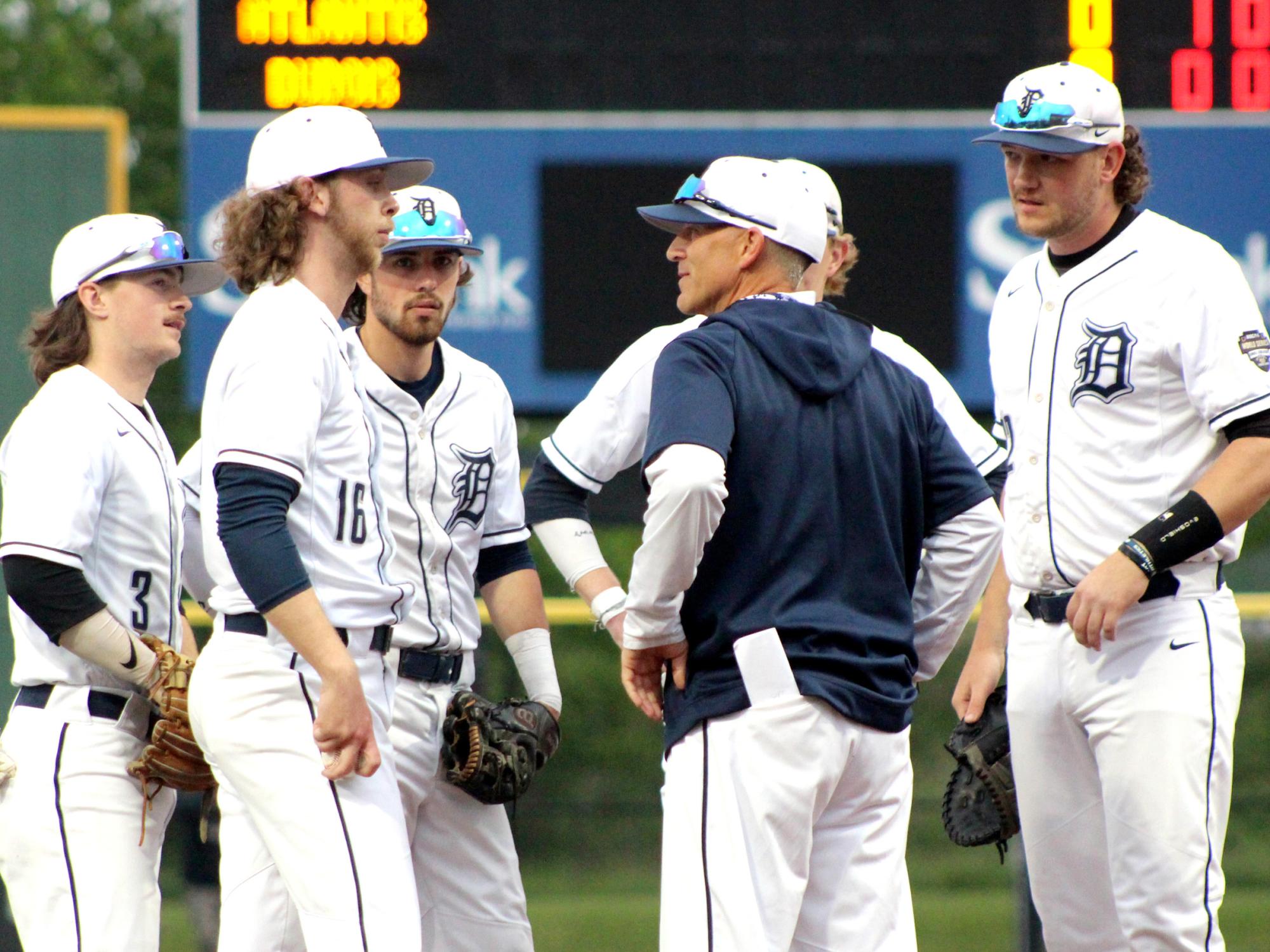 Former Penn State DuBois head coach Tom Calliari, center, talks with his players during a mound visit in a game during the USCAA Small College World Series.