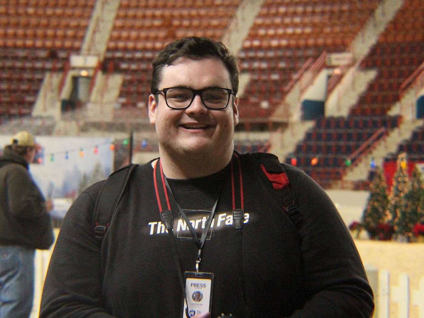 Smiling man with short dark hair and glasses
