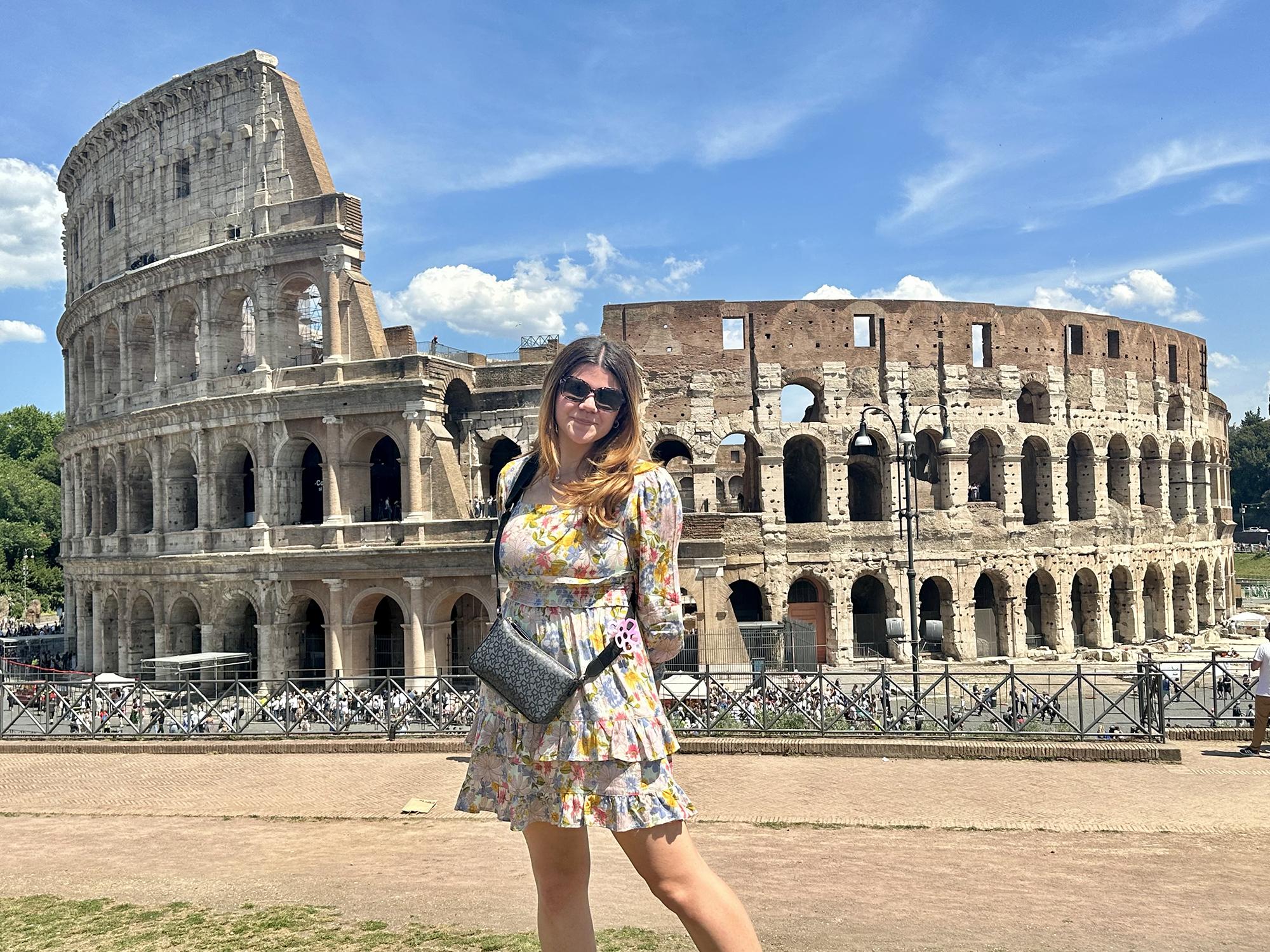 Monica Pineiro in front of the Colosseum in Rome, Italy