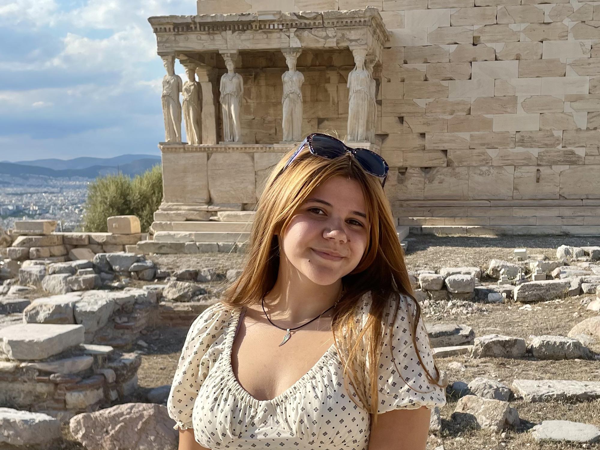 Monica Pineiro in front of ruins in Athens, Greece