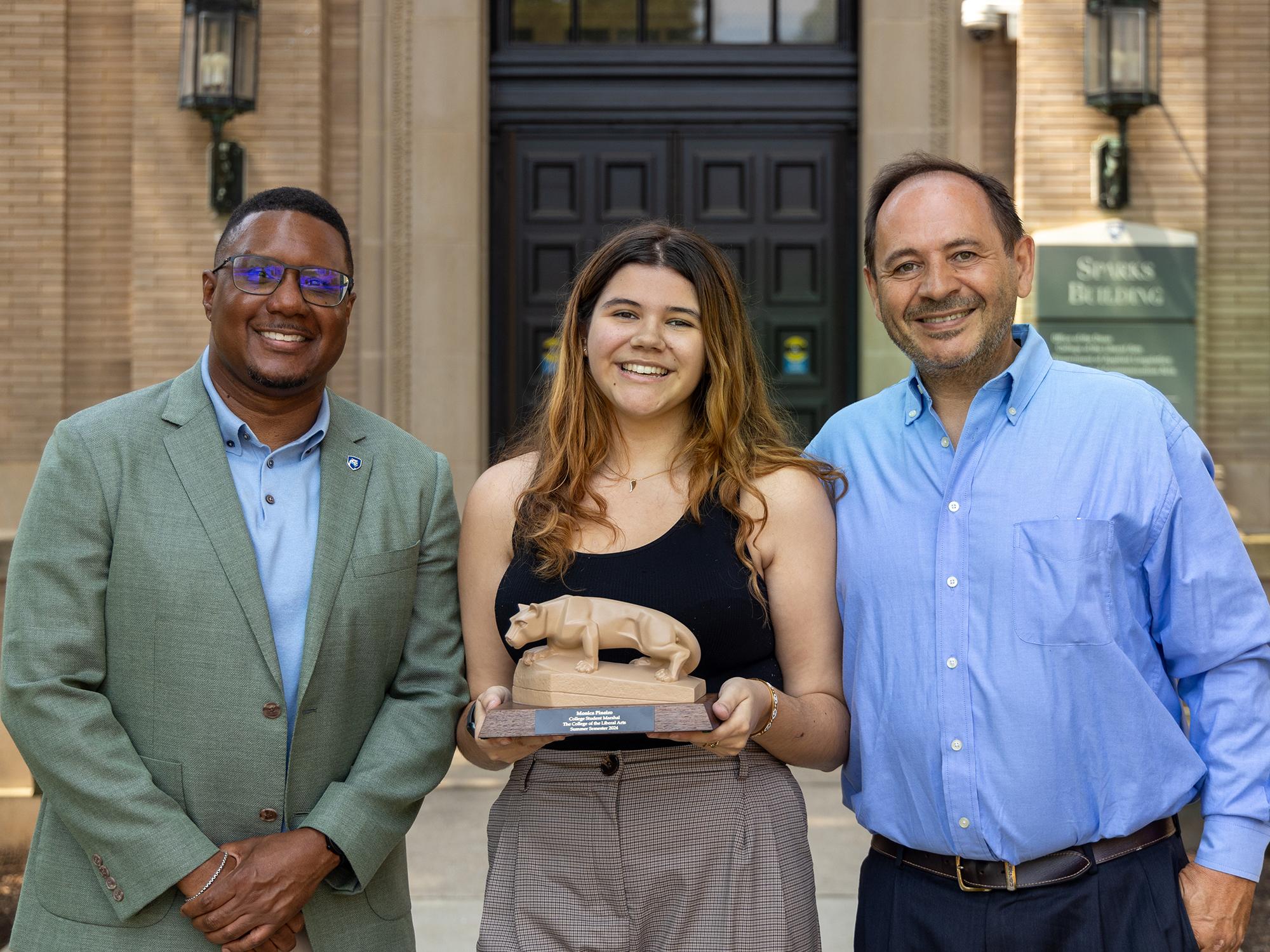 Clarence Lang (left), Monica Pineiro (center), and Daniel Pineiro (right), stand outside the north entrance of Sparks Building at Penn State University Park.