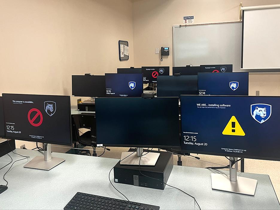 Computers on tables in a campus computer lab.