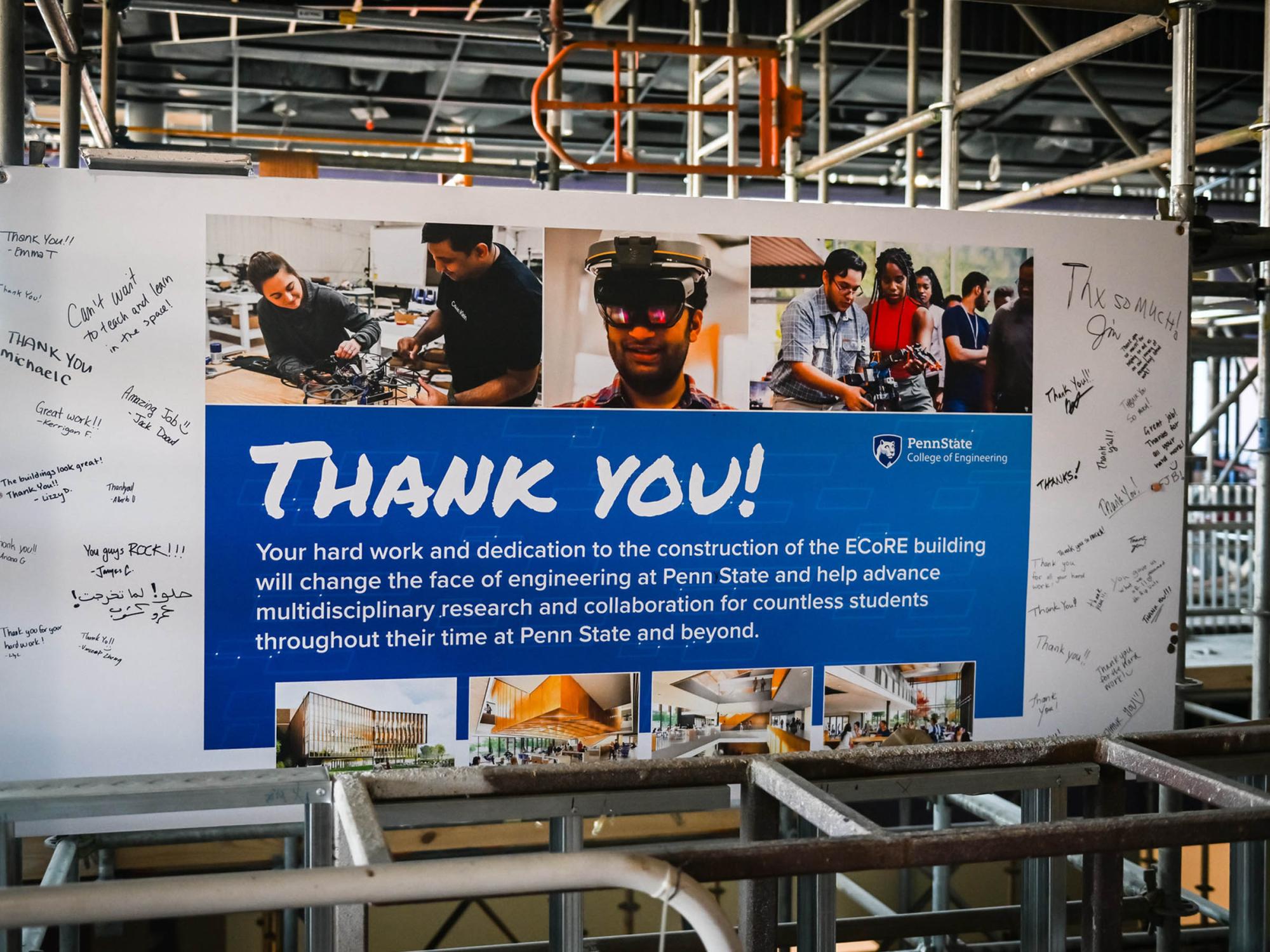 a sign thanking workers hanging in an area under construction in a new building