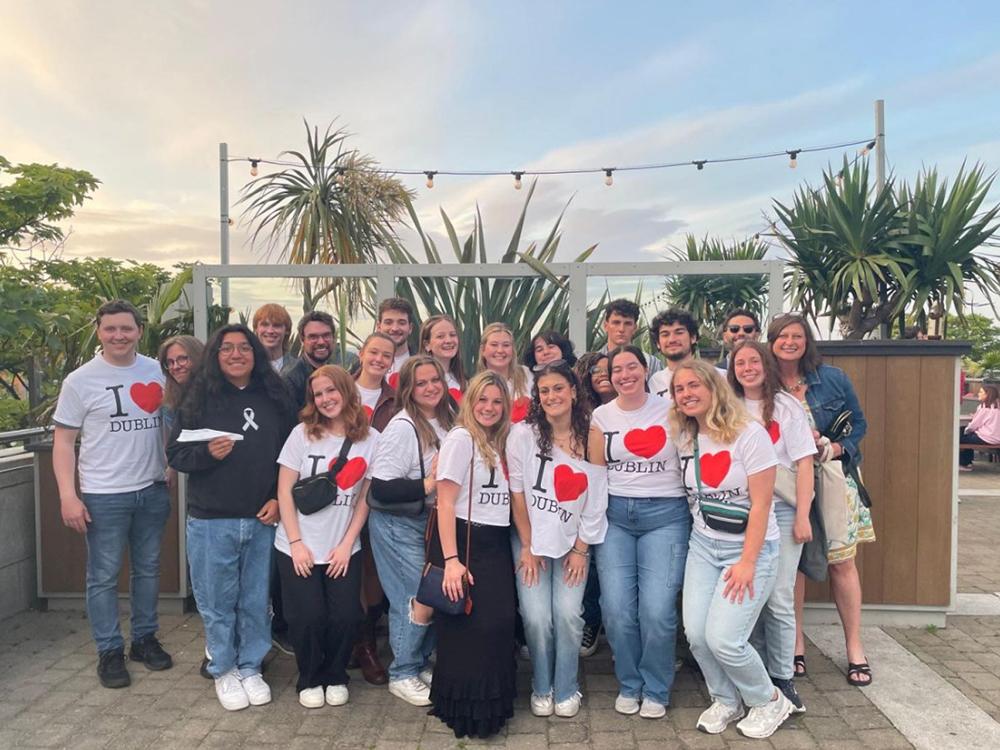 A group of students and professors pose wearing “I Love Dublin” shirts.