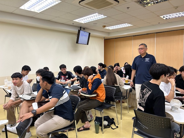 a teaching speaks to a classroom full of students
