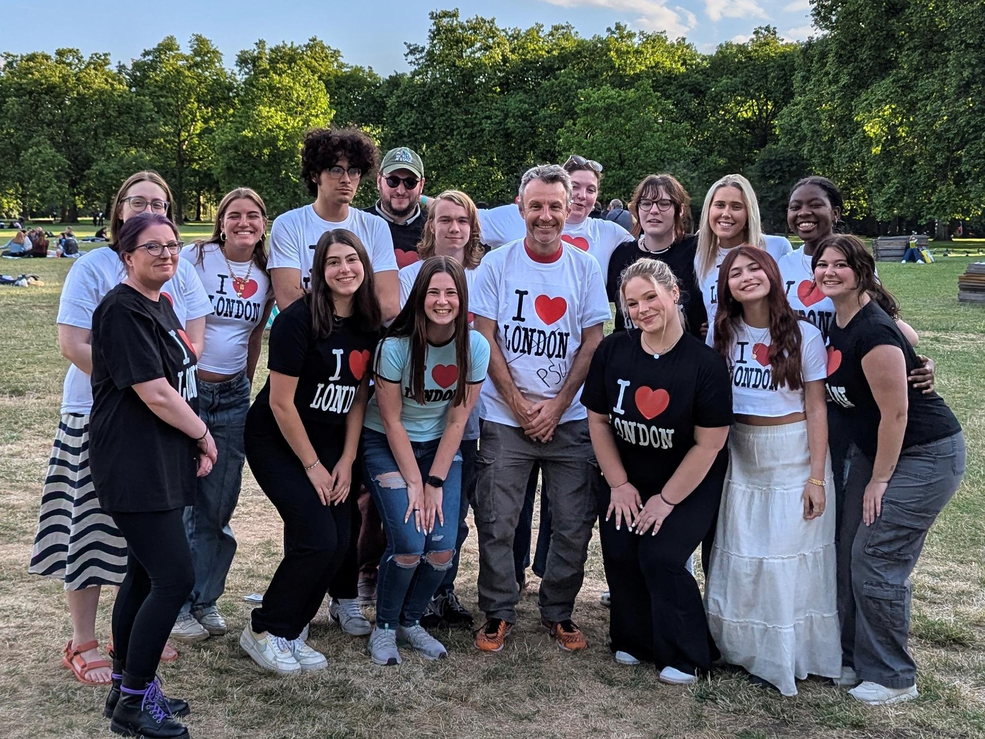 The class poses in a field wearing matching “I heart London” shirts.