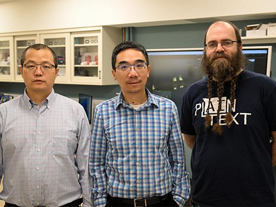 A posed photo of three people in a lab