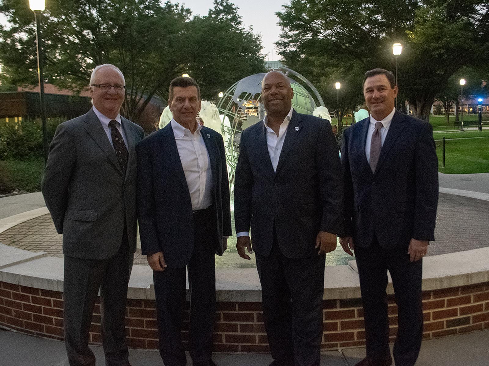 Winners of the Alumni Achievement Award gather at the fountain at Penn State Harrisburg