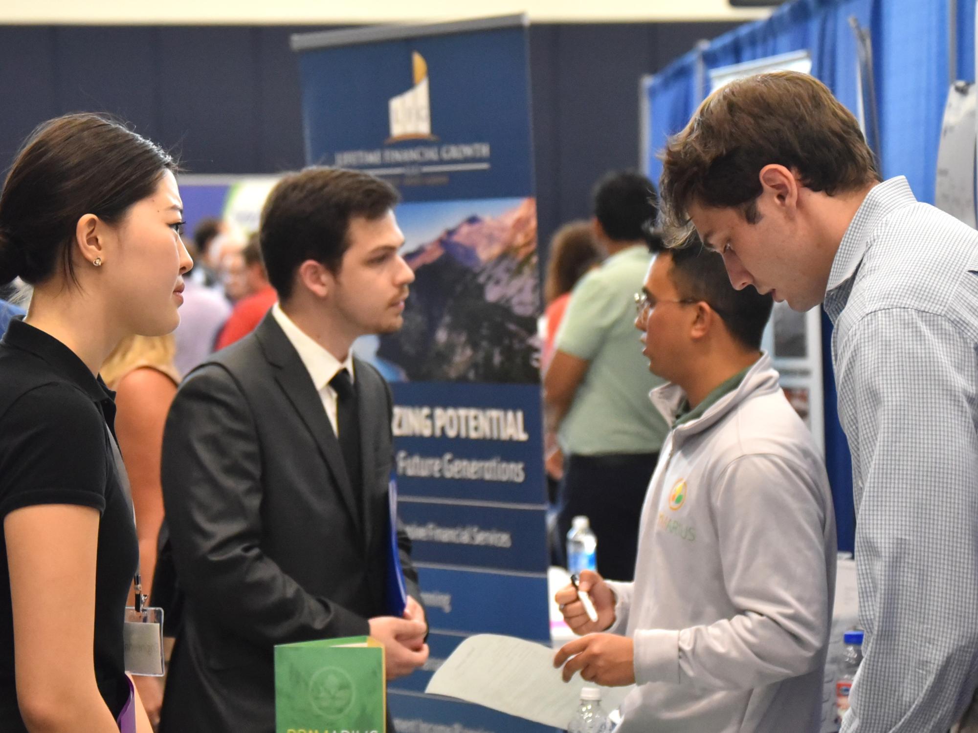 Students talk with recruiters at the Penn State Behrend career fair.