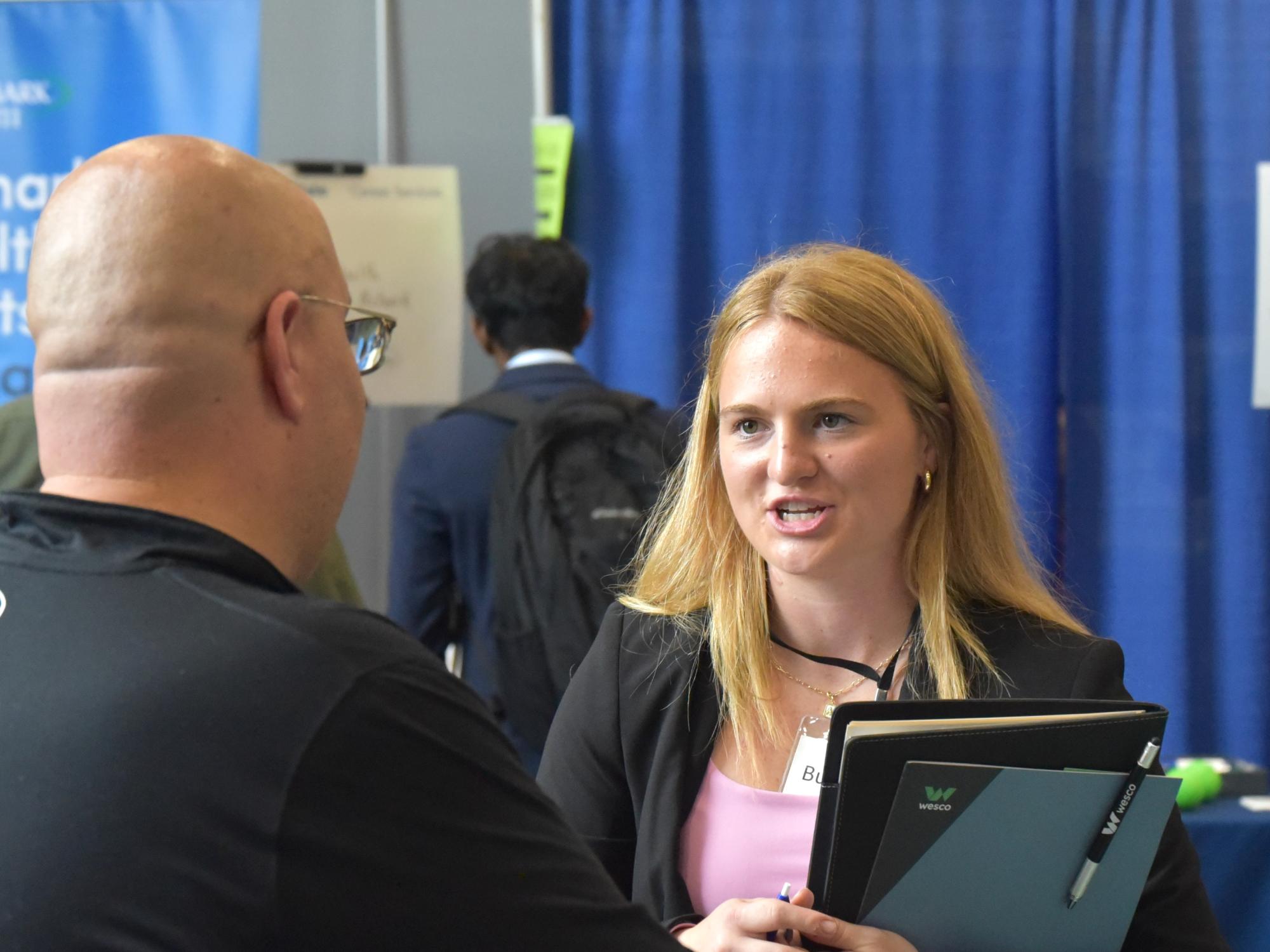 A student talks with a recruiter at Penn State Behrend's fall Career and Internship Fair.