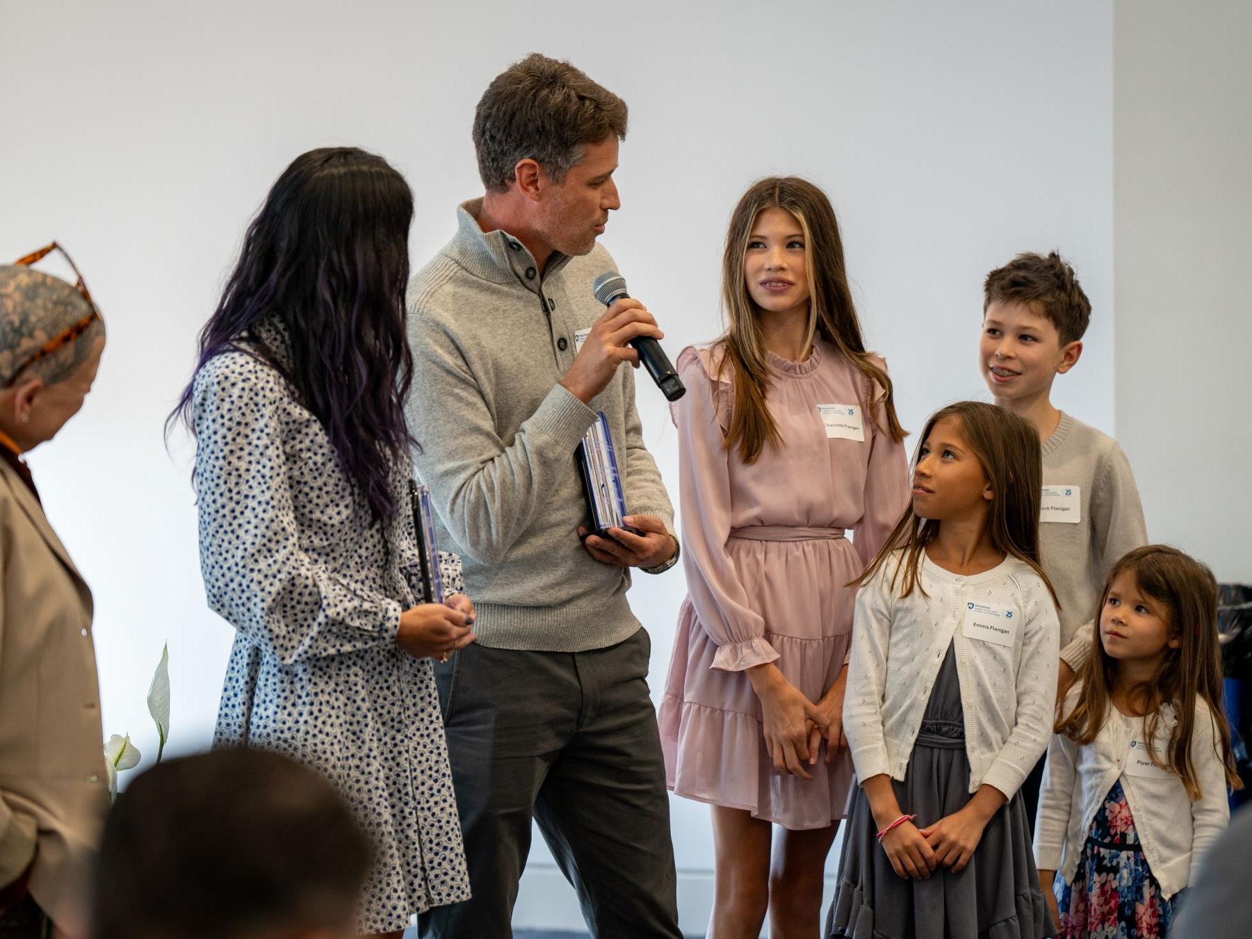 father with microphone addresses his family