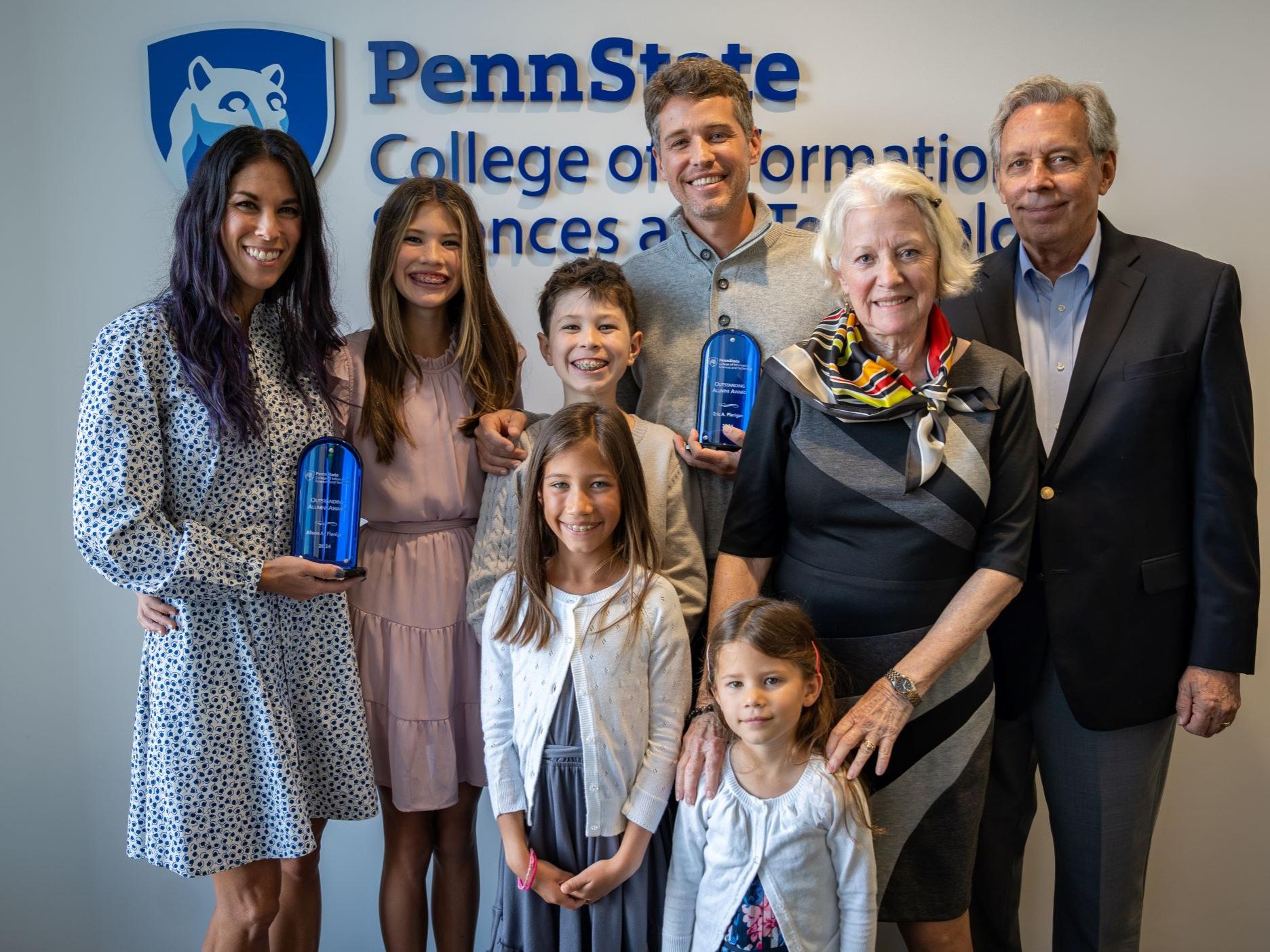 family of eight display awards at college event