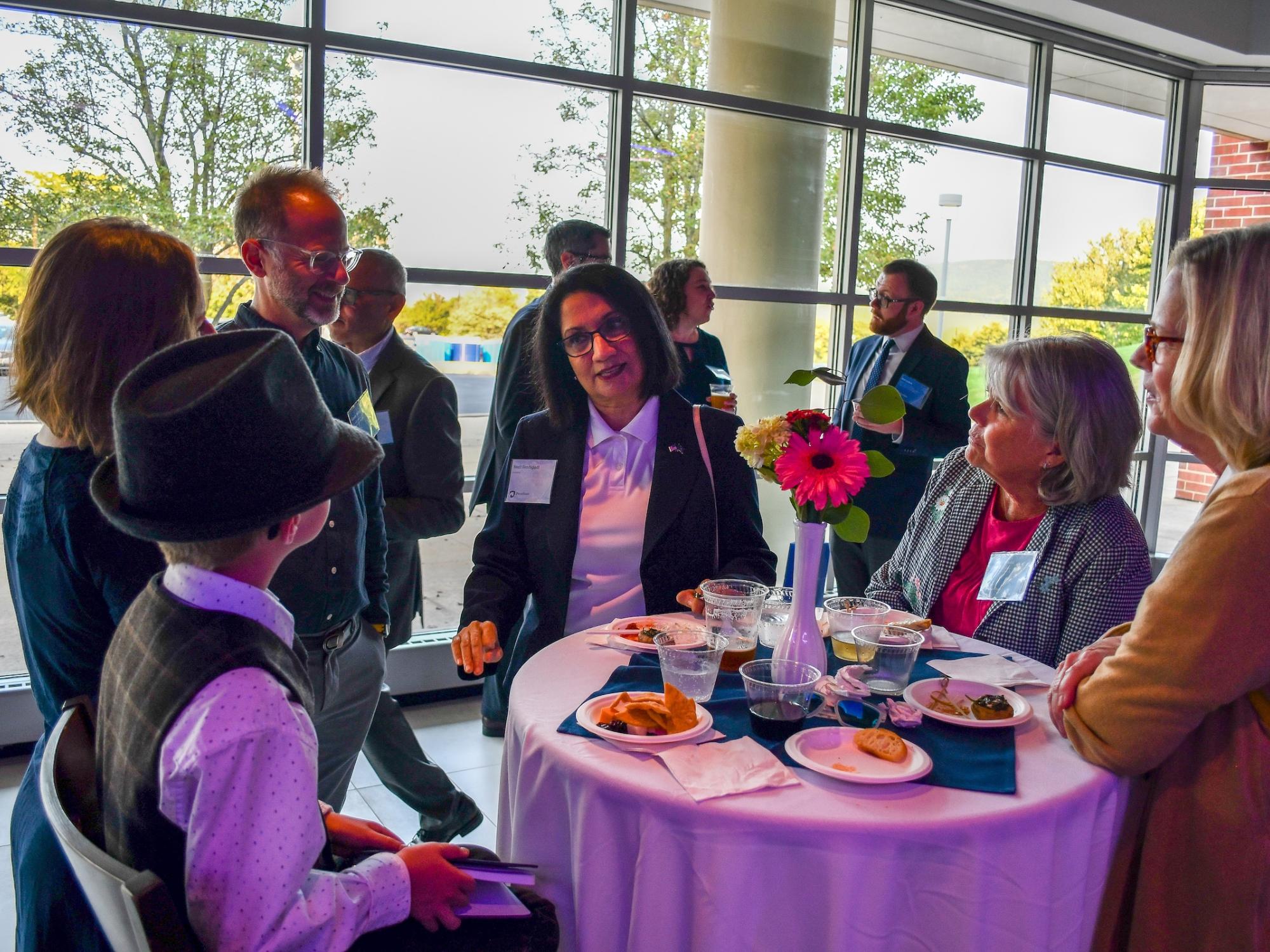 President Neeli Bendapudi chatting with faculty and families