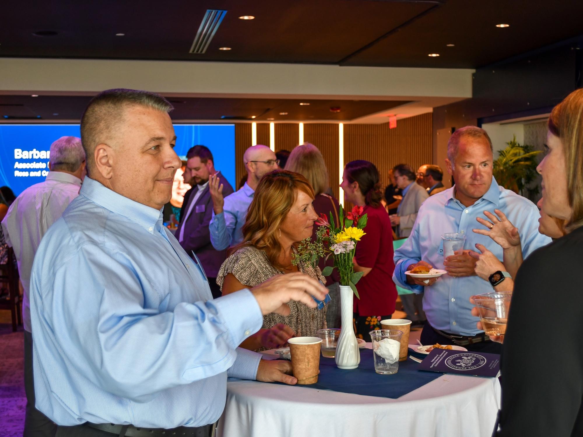 Faculty guests talk over dinner