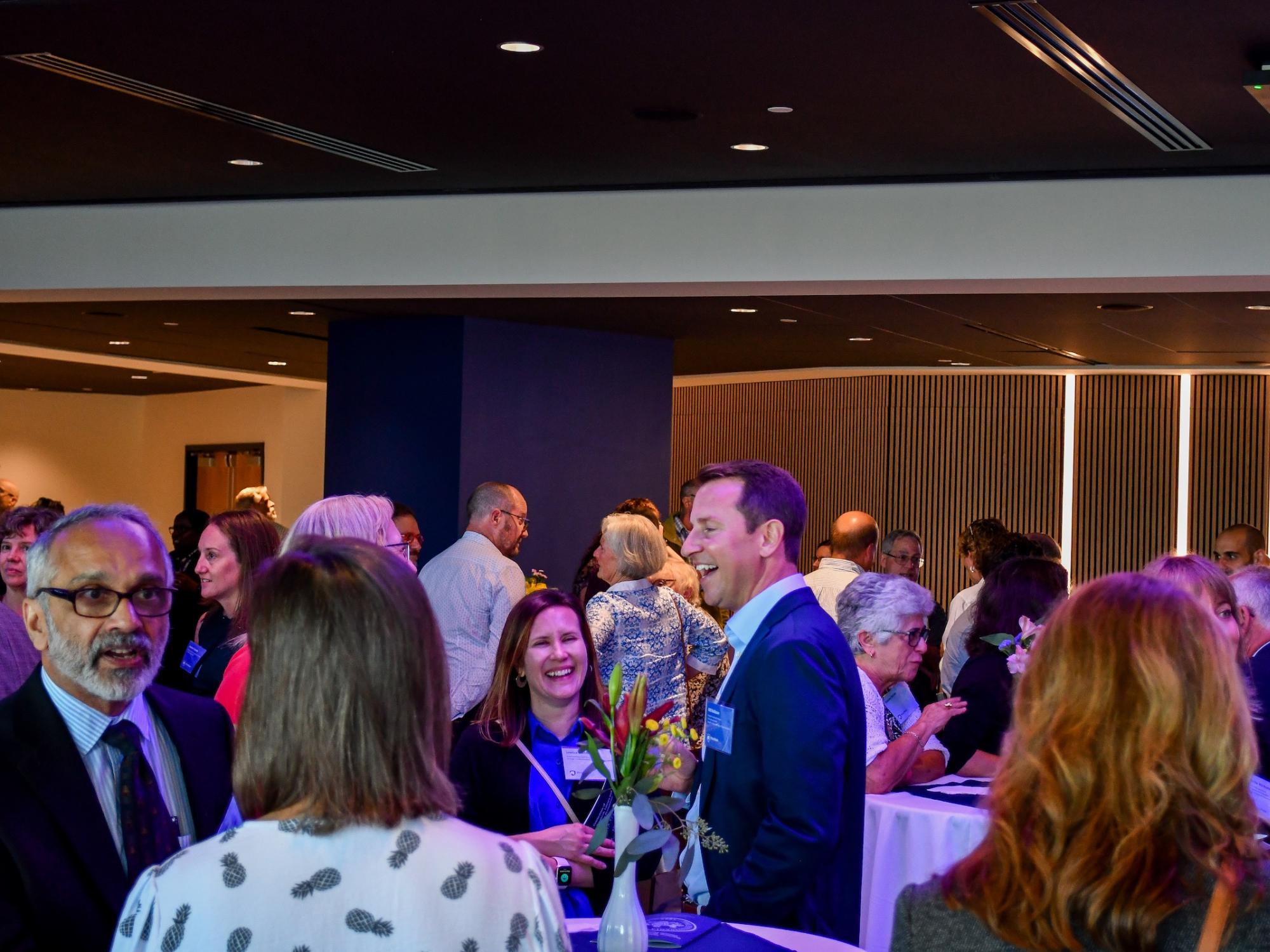 Room of faculty guests mingle