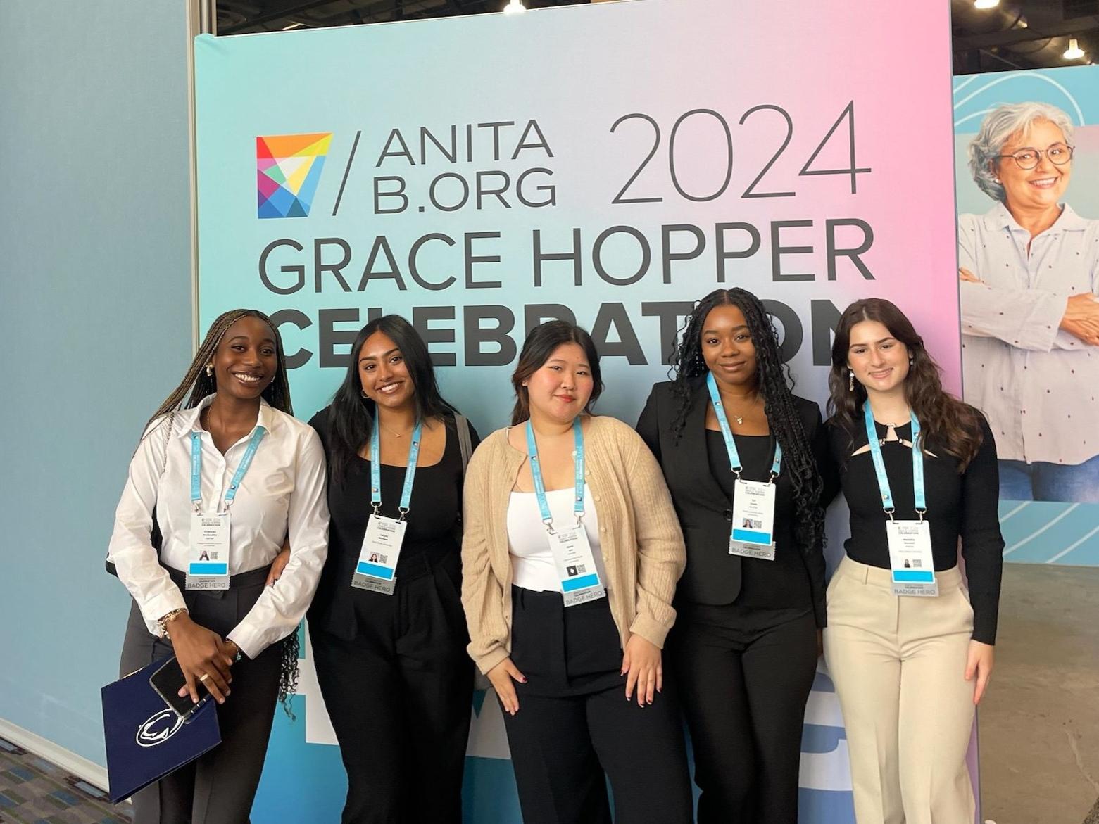 five college students wearing lanyards at conference