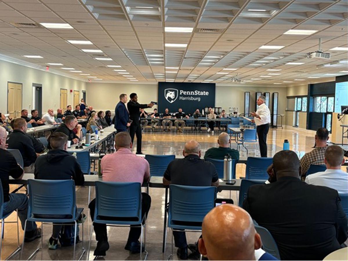 Second-year Penn State Altoona student Ray Ncube participates in a taser simulation exercise with officers from the Pennsylvania State Police as part of the Keystone Model crisis management workshop at Penn State Harrisburg.