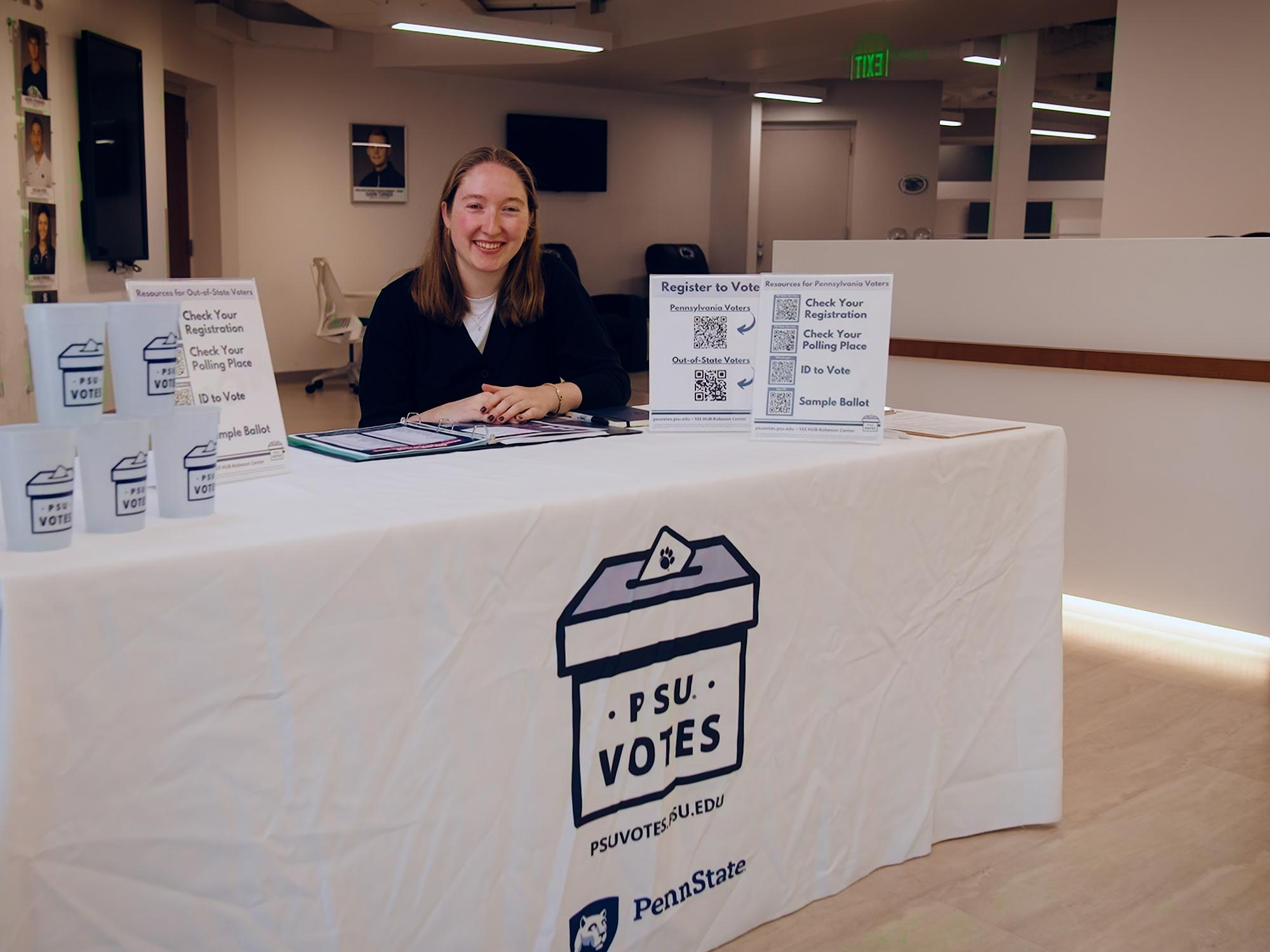 Maddie Hindman sits behind the PSU Votes table in the Morgan Academic Center earlier this fall.