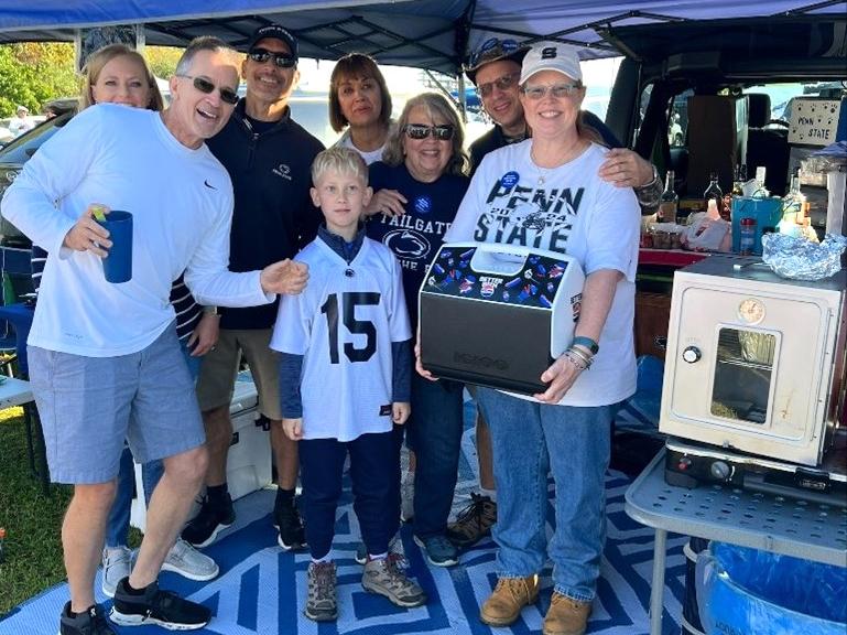 A family in their tailgate tent at a football game.