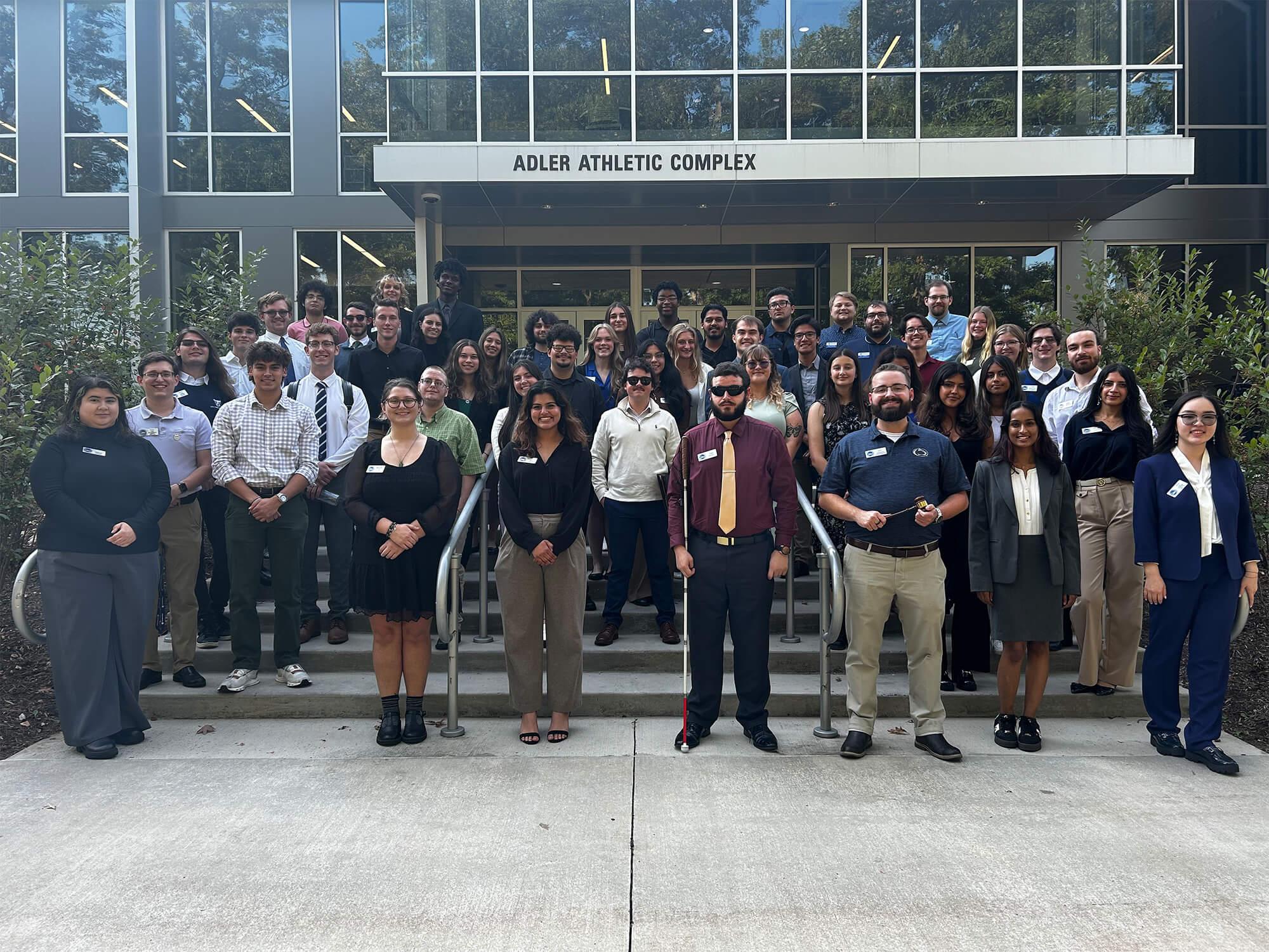 Students line up for a group picture in front of the Adler Athletic Complex at Penn State Altoona.