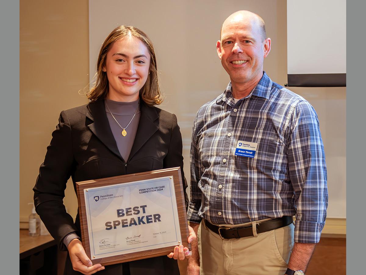 Penn State student Layla Gilbert poses with faculty member Bruce Tirrell after receiving Best Speaker Award